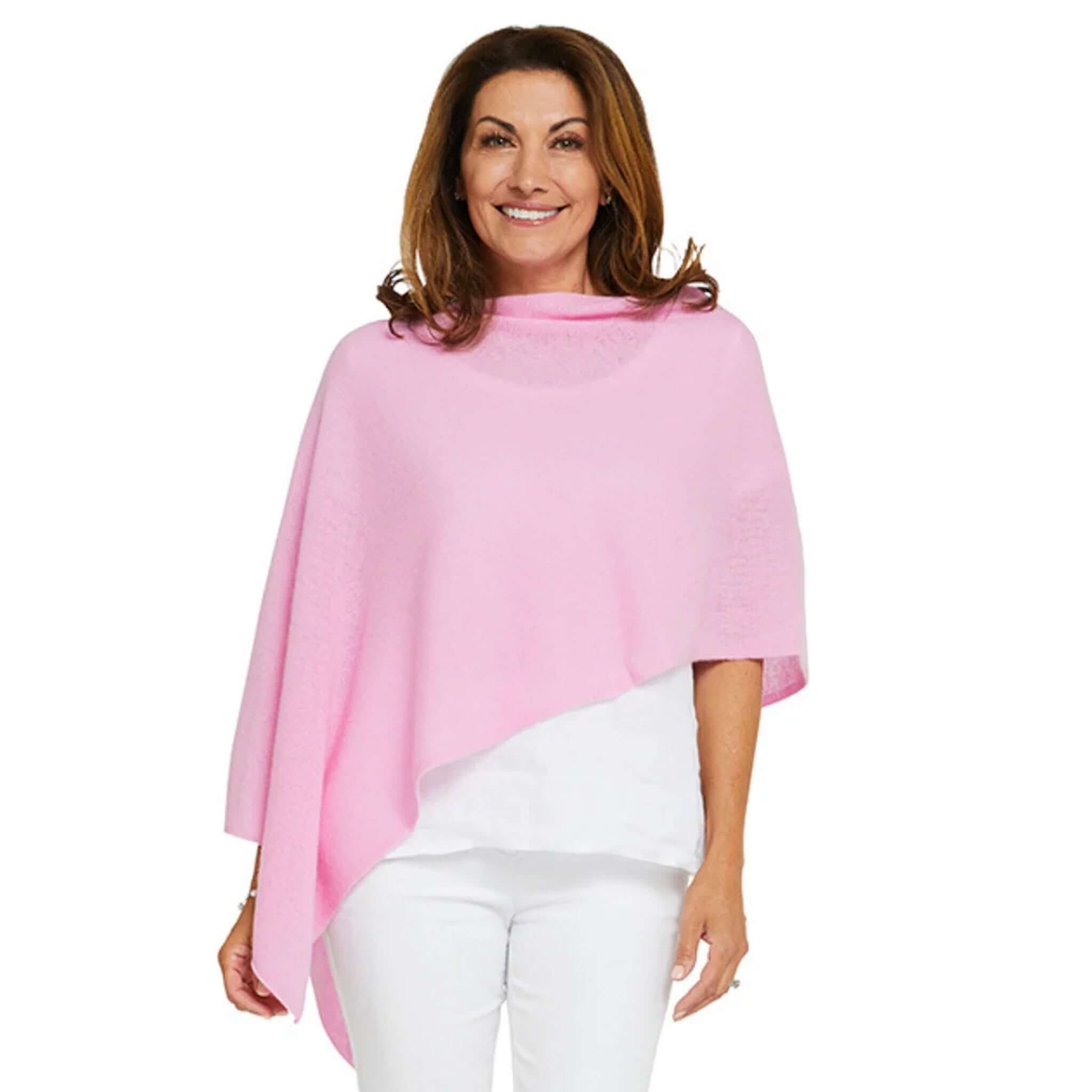 Esperance & Co Classic Cashmere Topper - Glam Pink worn by a smiling woman, showcasing its elegant style and versatility.