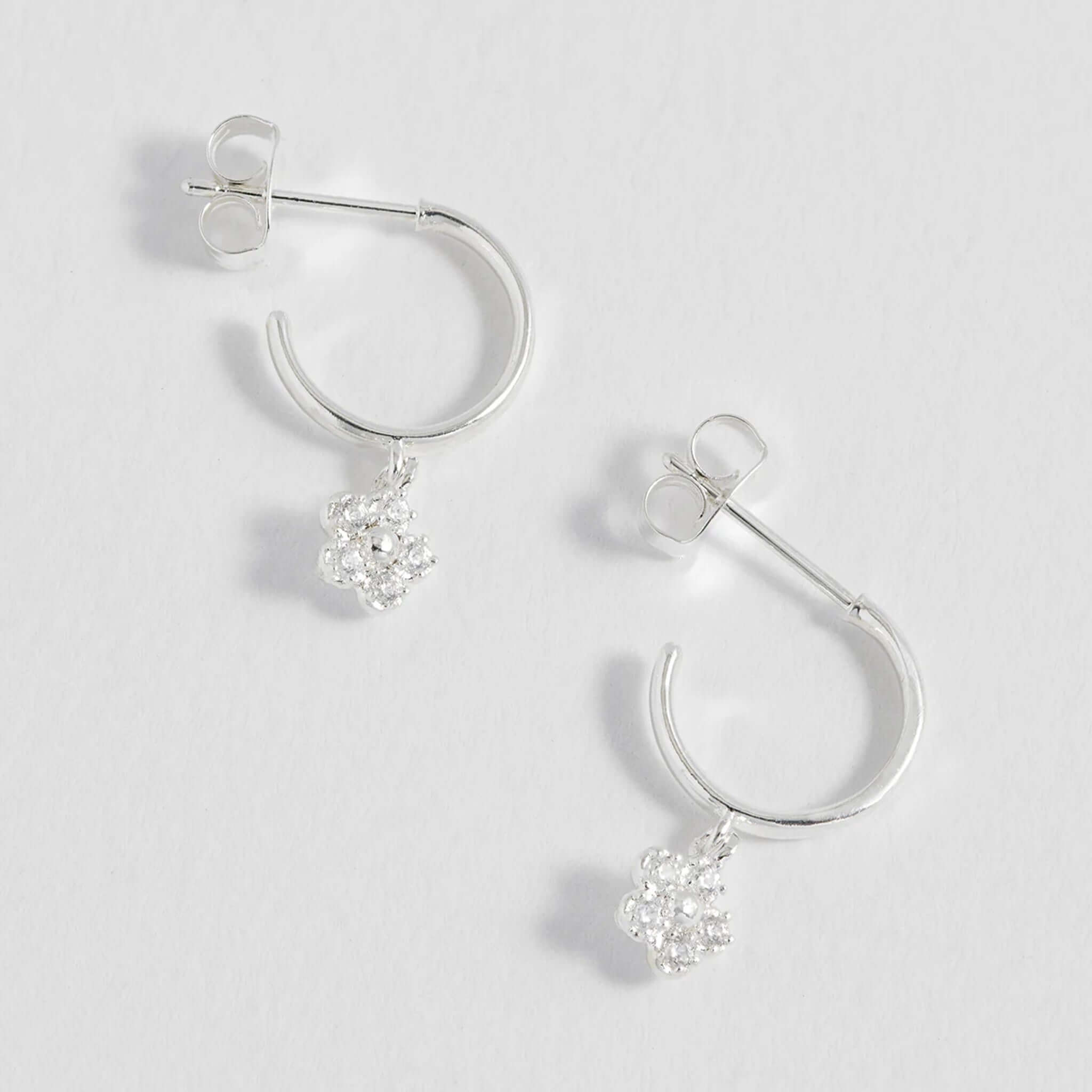 Alt Tag: Estella Bartlett Flower Hoop CZ Earrings - Silver silver-plated hoop earrings with sparkling cubic zirconia daisy charm