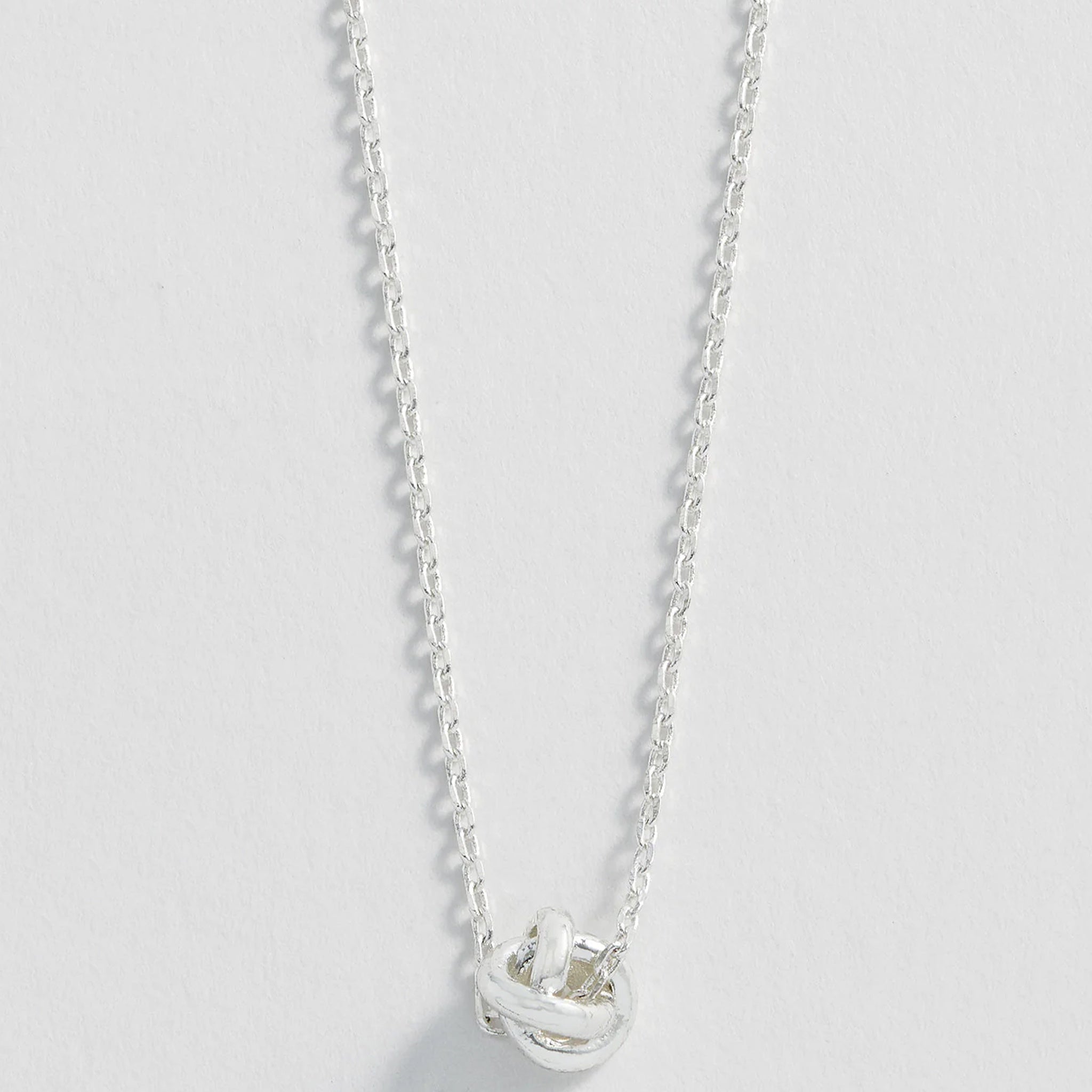 Silver knot necklace.