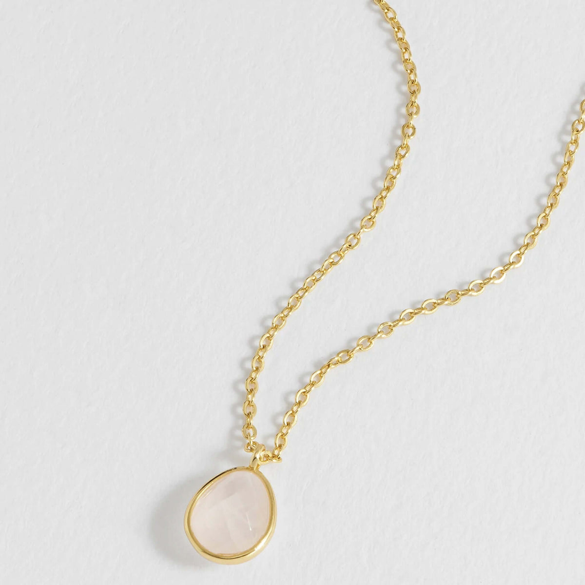 Estella Bartlett Wellness Faceted Teardrop Necklace - Rose Quartz on a gold-plated chain with a rose quartz pendant.