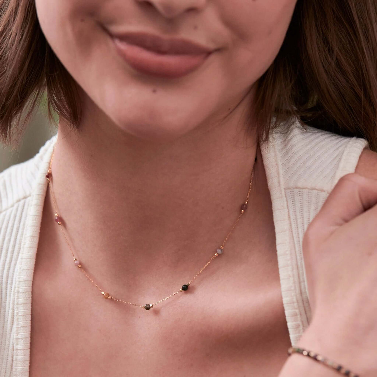 Estella Bartlett Wellness Beaded Chain Necklace - Tourmaline worn by a model, showcasing colorful natural tourmaline beads.