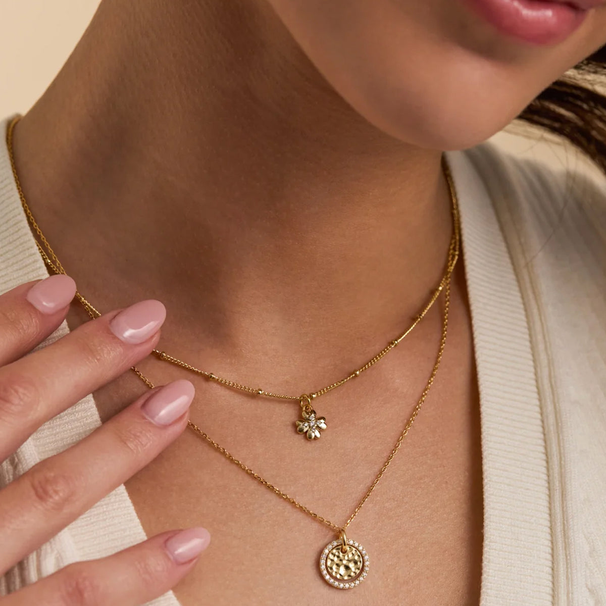 Estella Bartlett Hammered Circle CZ Necklace worn layered with a second gold chain