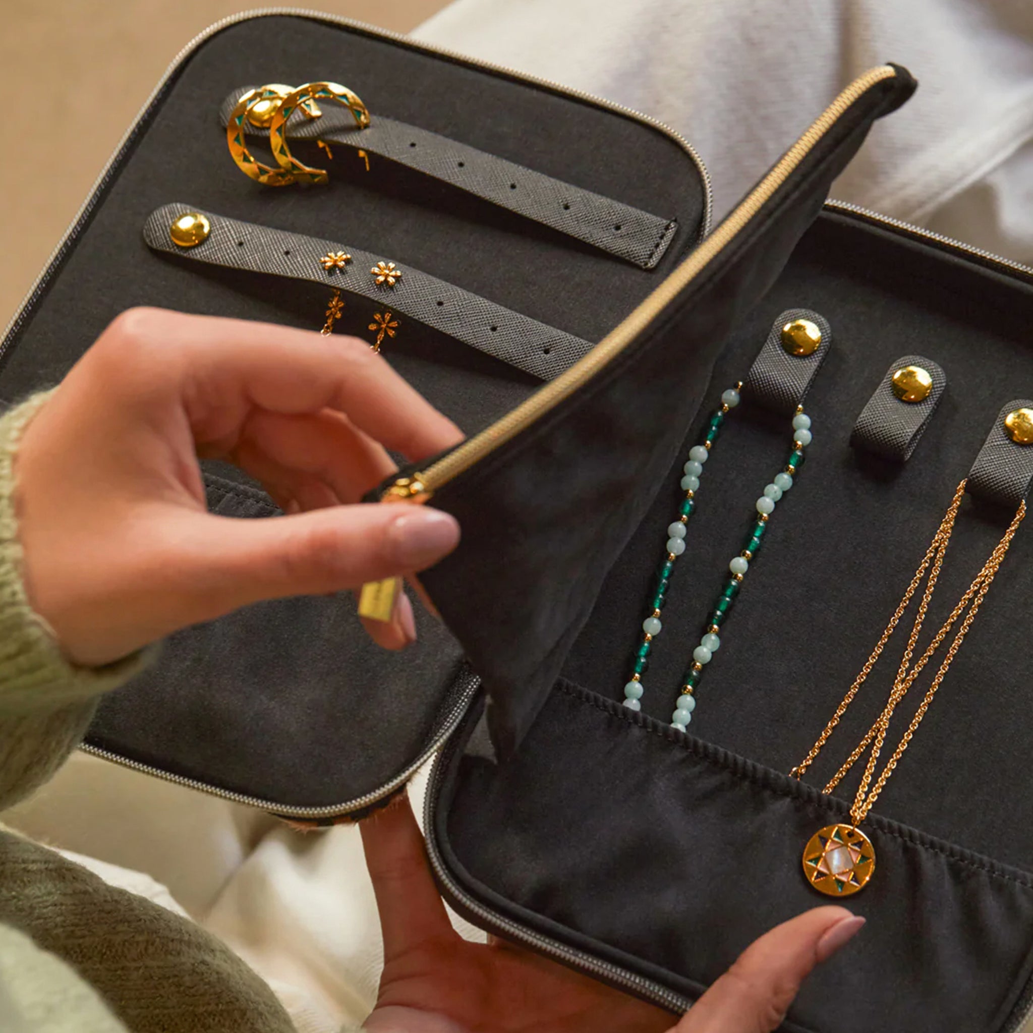 Jewelry set including necklaces and earrings in a black jewelry case.
