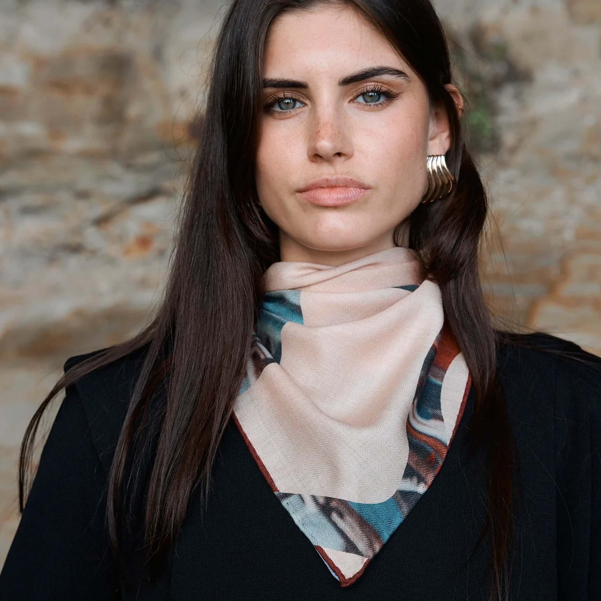 Alt Tag: Good & Co Heritage Triangle Wool & Silk Scarf - Blush worn as blush triangle neck scarf with heritage logo print, wool-silk herringbone weave