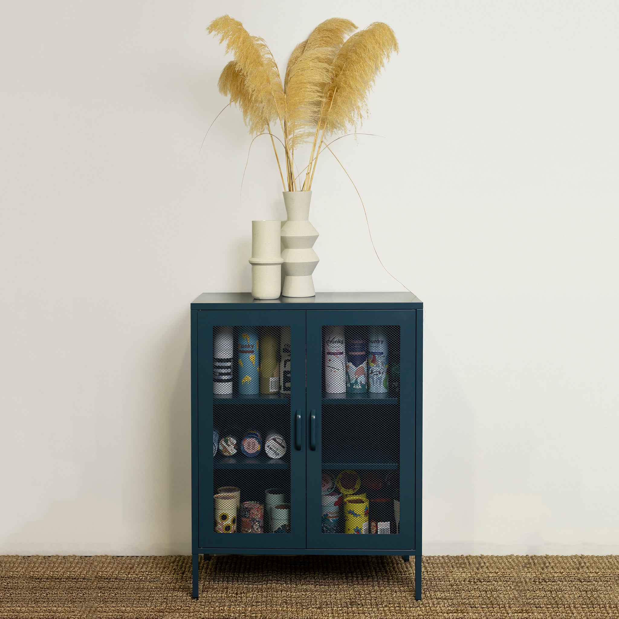 A blue contemporary metal locker with mesh cupboards and steel shelves.