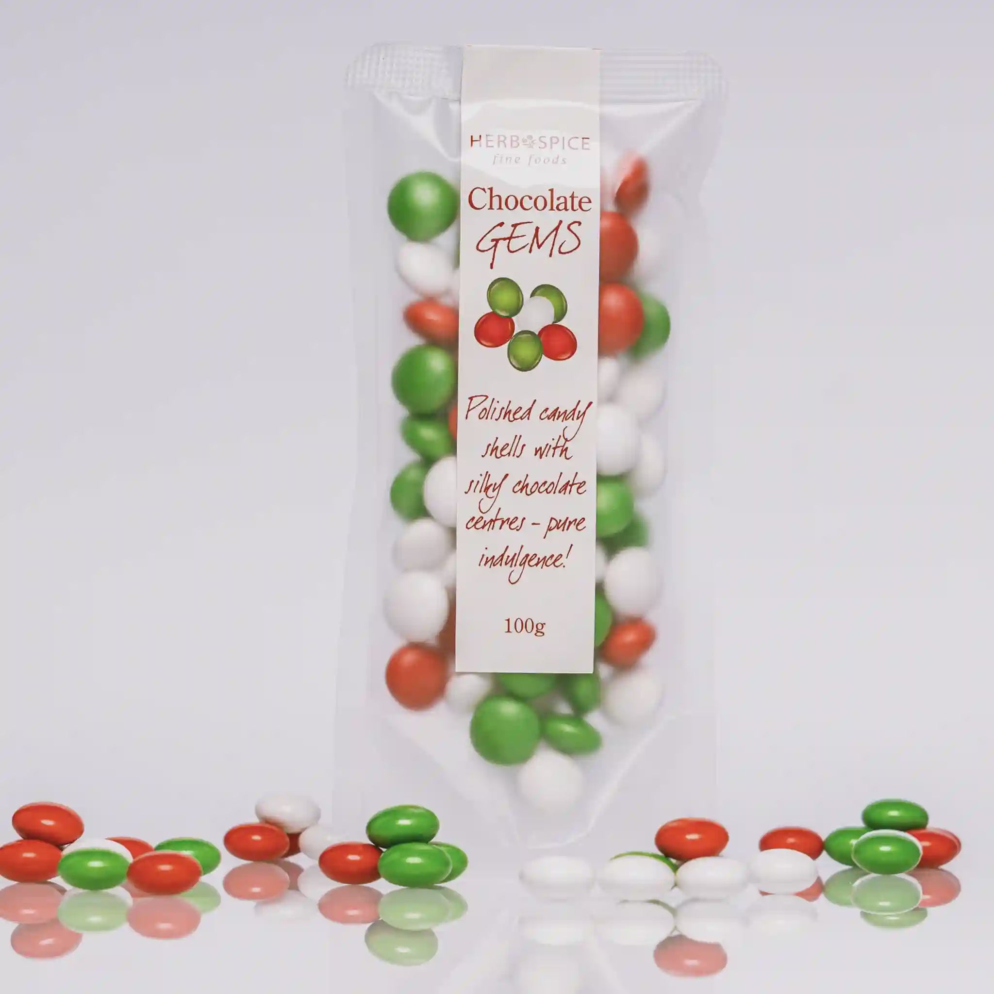 Packaged chocolate gems with a white label on a light gray background