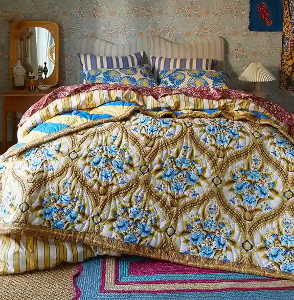 Decorative bedspread with floral patterns in a bedroom setting