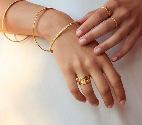 Woman's hand with rings and bracelets.