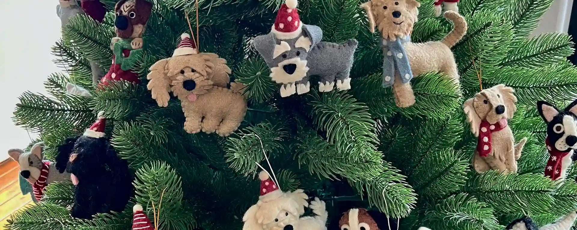 Decorative Christmas tree with various dog-shaped ornaments.