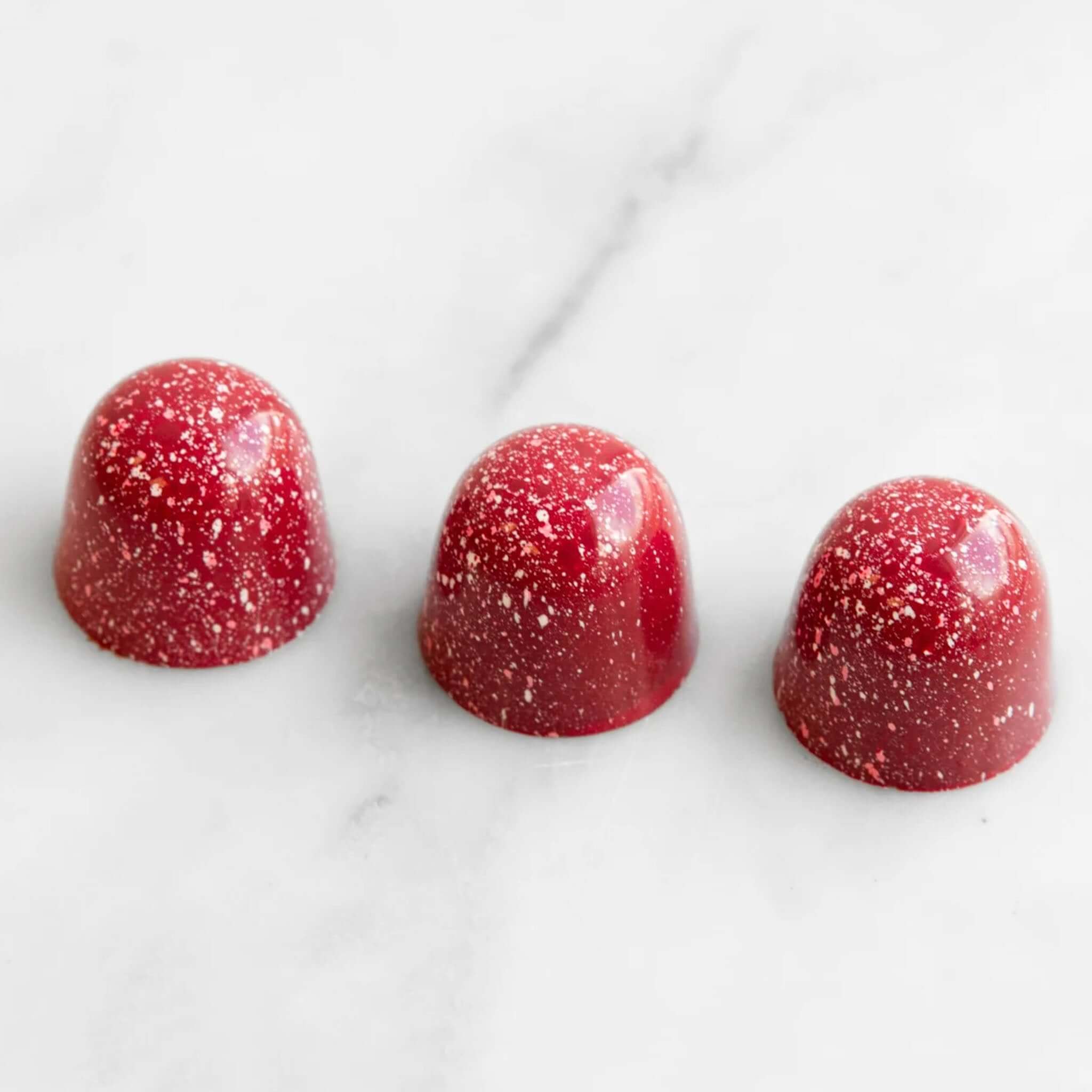 Alt Tag: House of Chocolate Be My Valentine Raspberry Creme Chocolate Bonbons red speckled bonbons in 55% dark chocolate, 3-piece