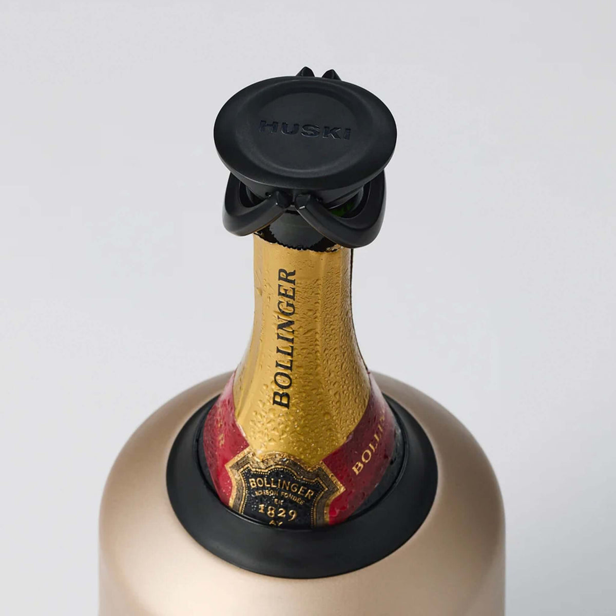 Huski BubbleLock Champagne Bottle Stopper on a sparkling wine bottle for preserving bubbles.