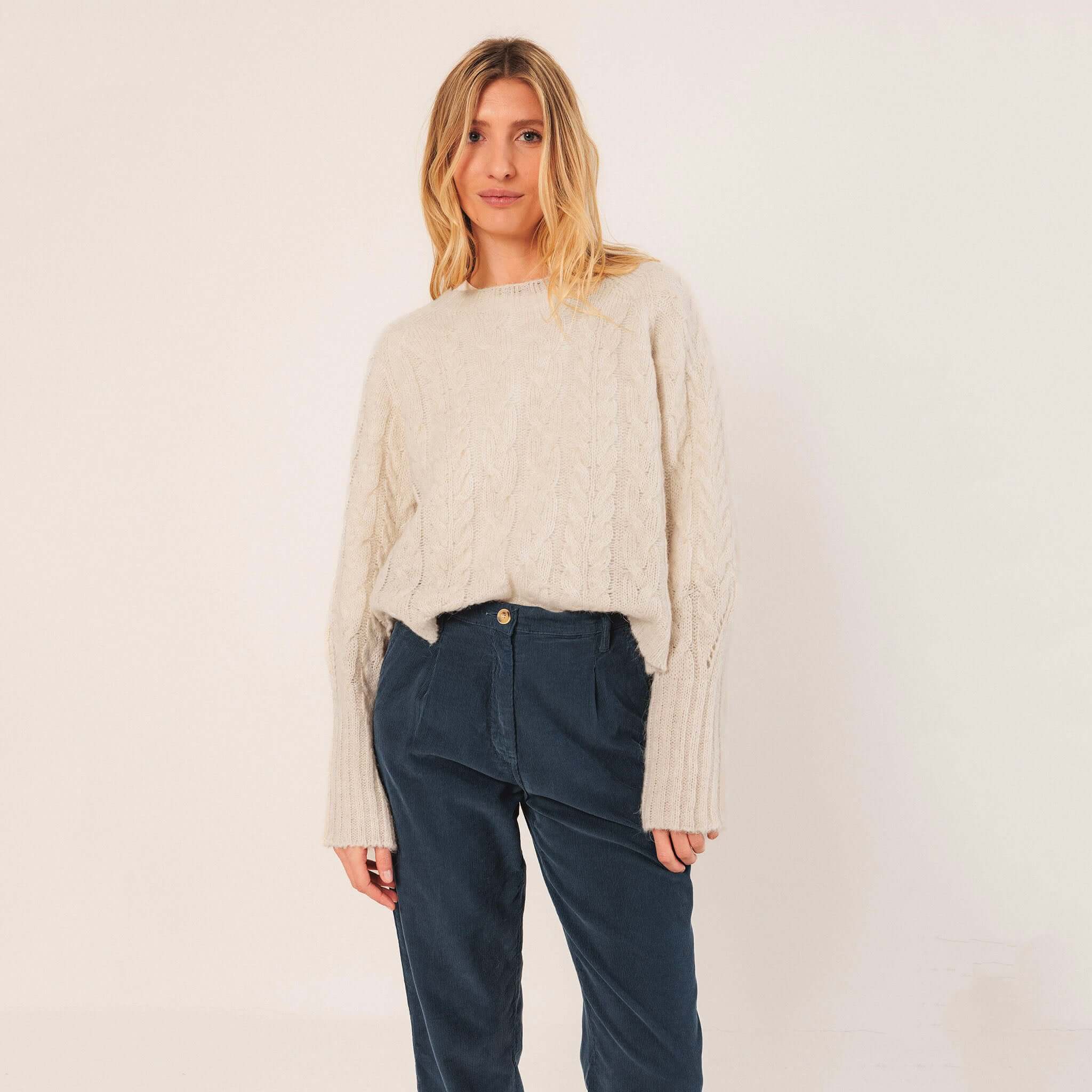 Alt Tag: Indi & Cold Cable Knit Aplaca Blend Jersey - Crudo off-white braided cable knit alpaca blend cropped sweater with raglan sleeves