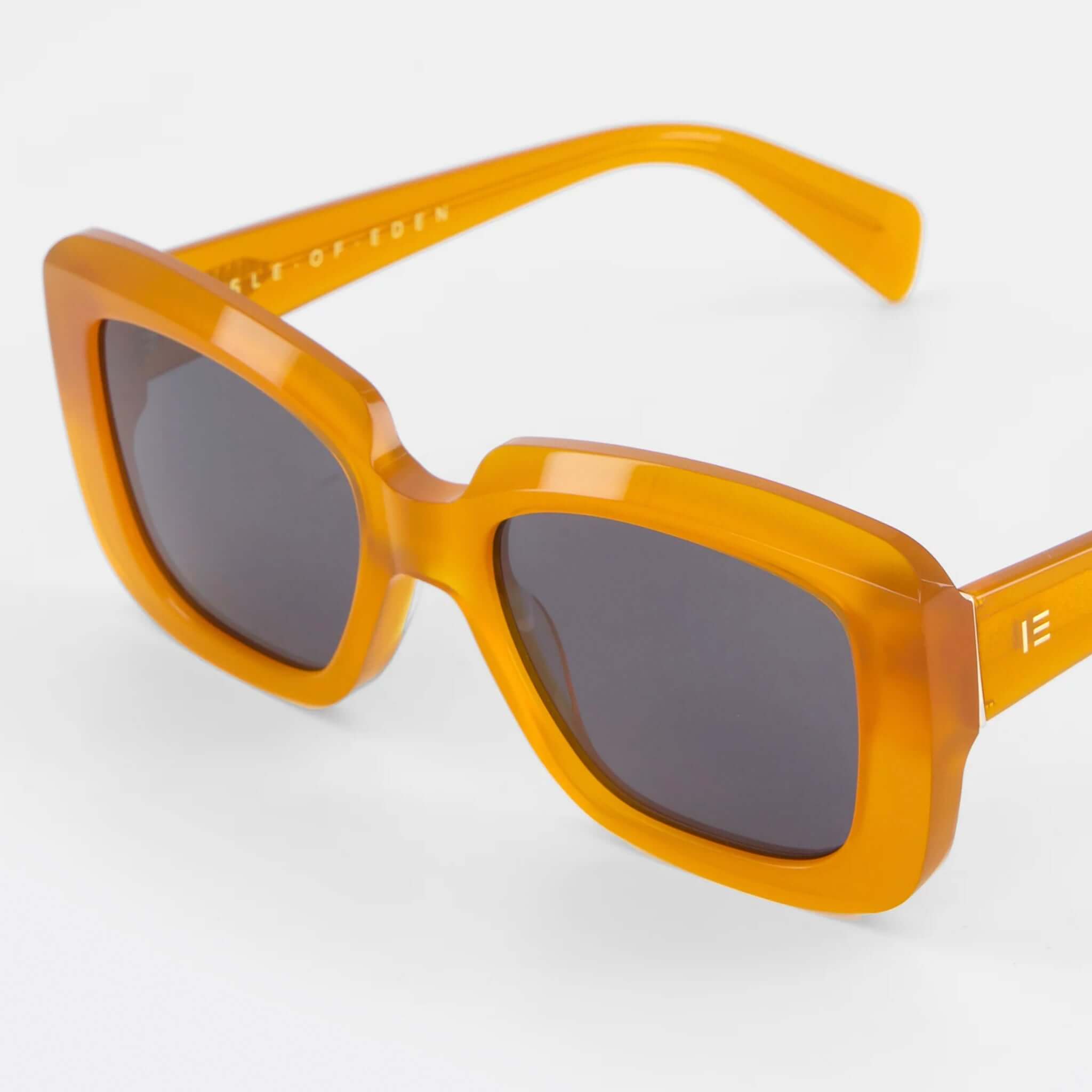 Alt Tag: Isle of Eden Sunglasses - Pia Peach large bold rectangular peach frame sunglasses with flat lenses and gold temple caps