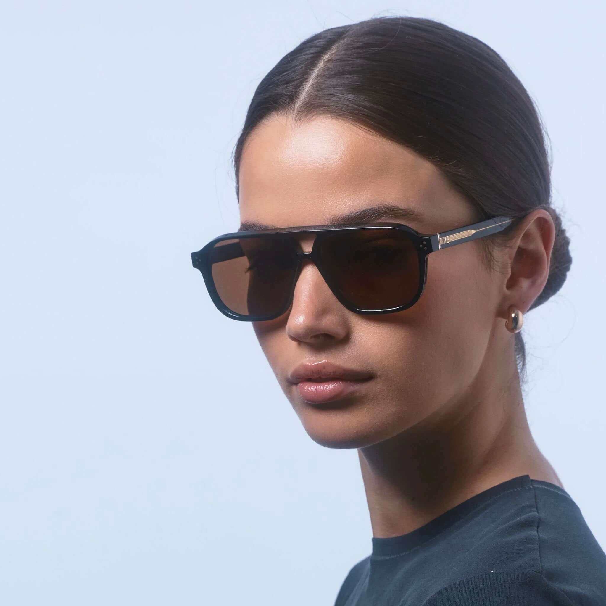 Alt Tag: Isle of Eden Sunglasses - Remi Whiskey Tortoise worn by model, modern aviator bio-acetate frame with bold double bridge