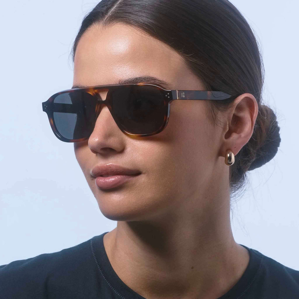 Isle of Eden Sunglasses - Remi Tortoise worn by model, showcasing modern aviator design with bio-acetate frame.