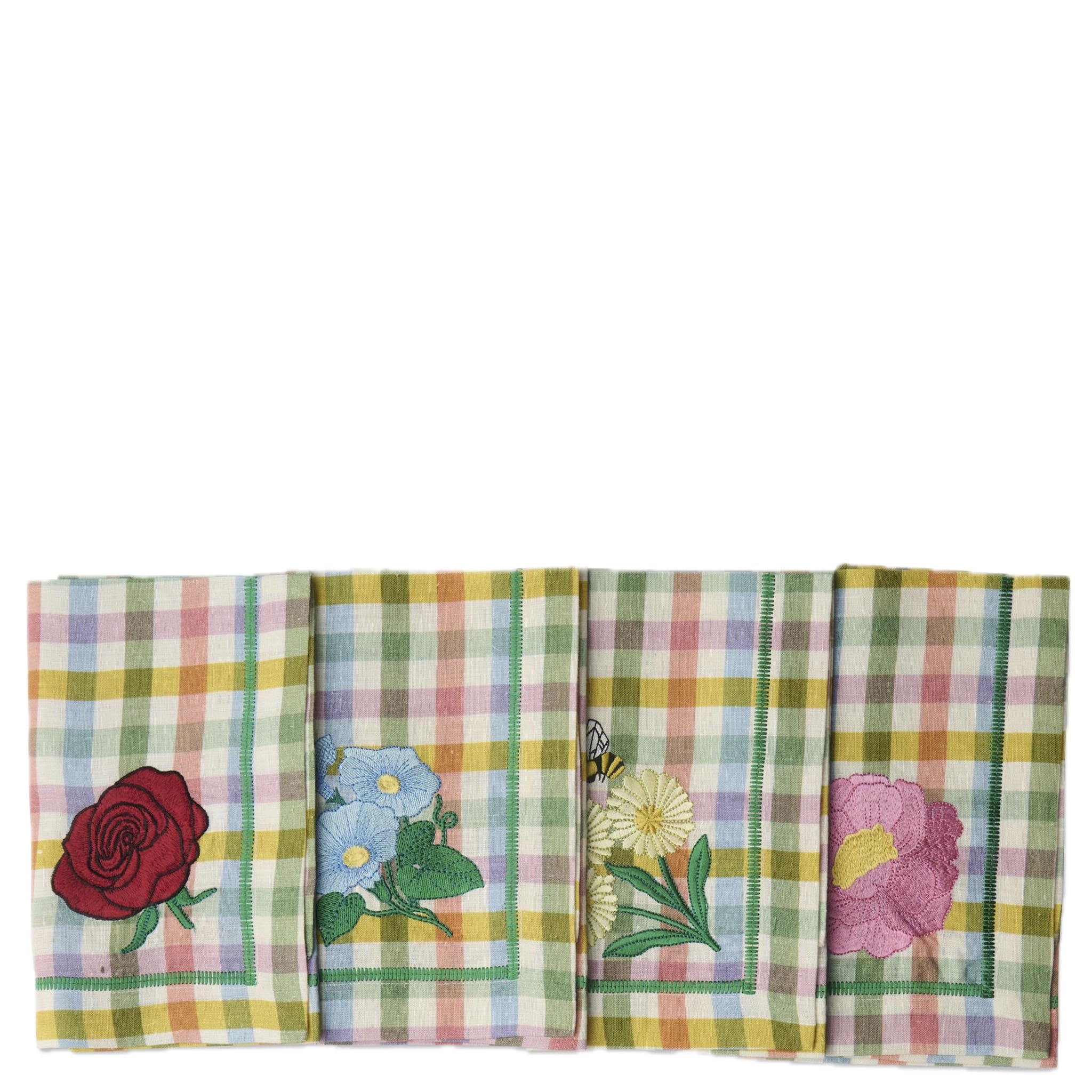 Set of four plaid napkins with floral and nature-themed designs on a white background