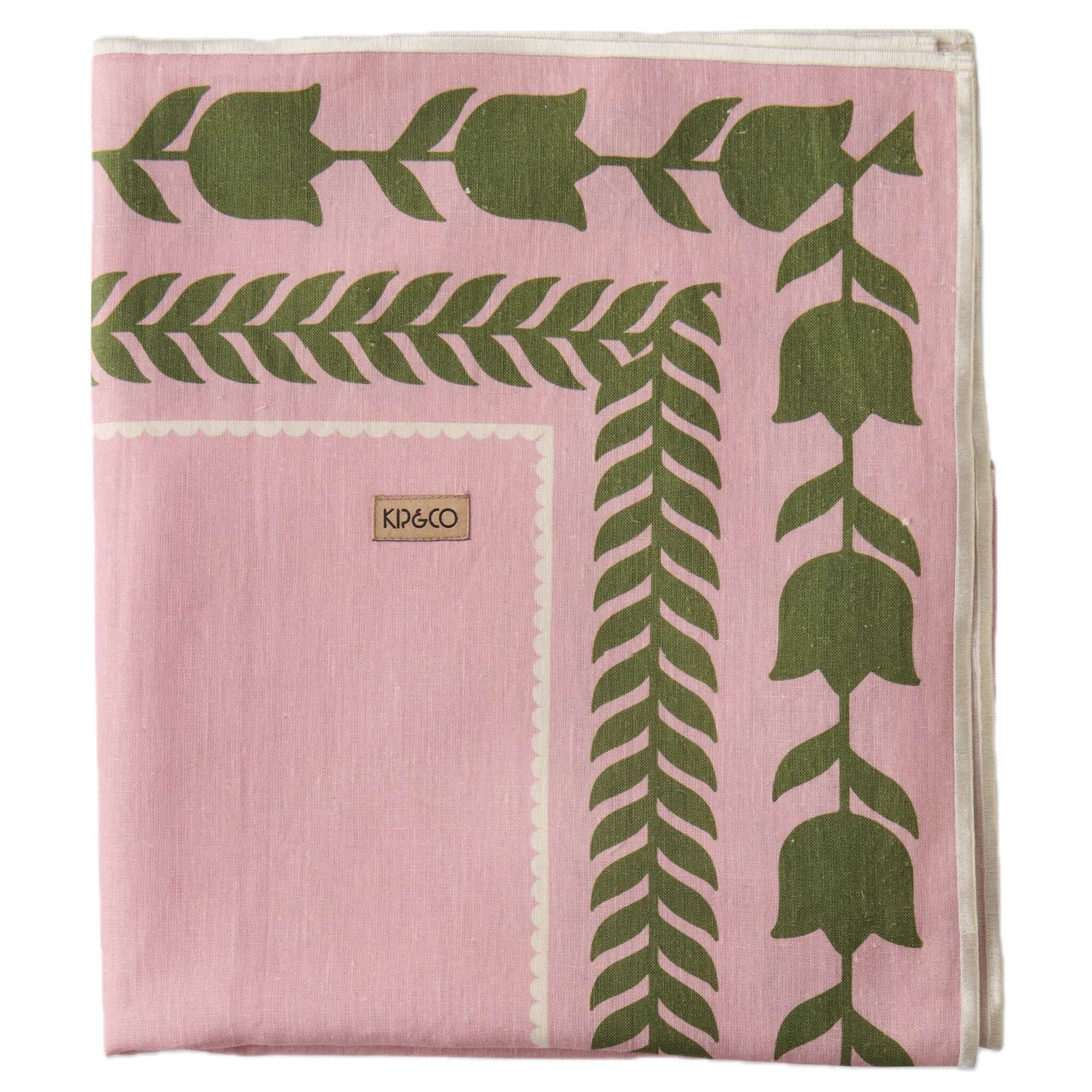 Alt Tag: Kip & Co Embroidered Linen Tablecloth - Flower Chain soft pink linen tablecloth with green tulip border and white embroidered edge