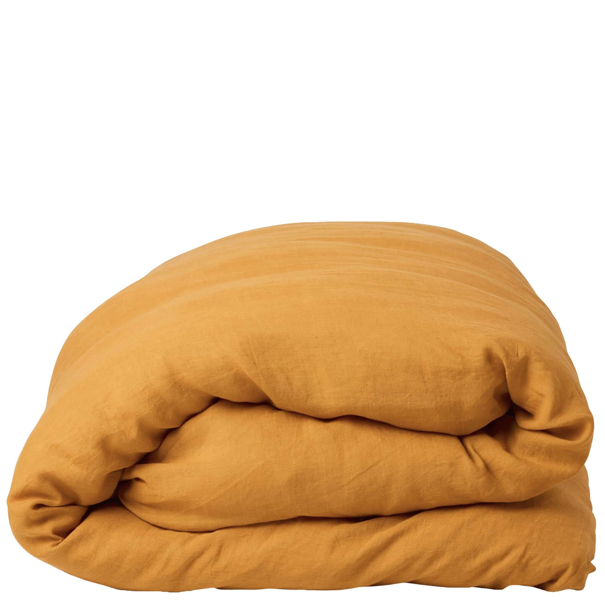 Folded mustard yellow duvet on a white background