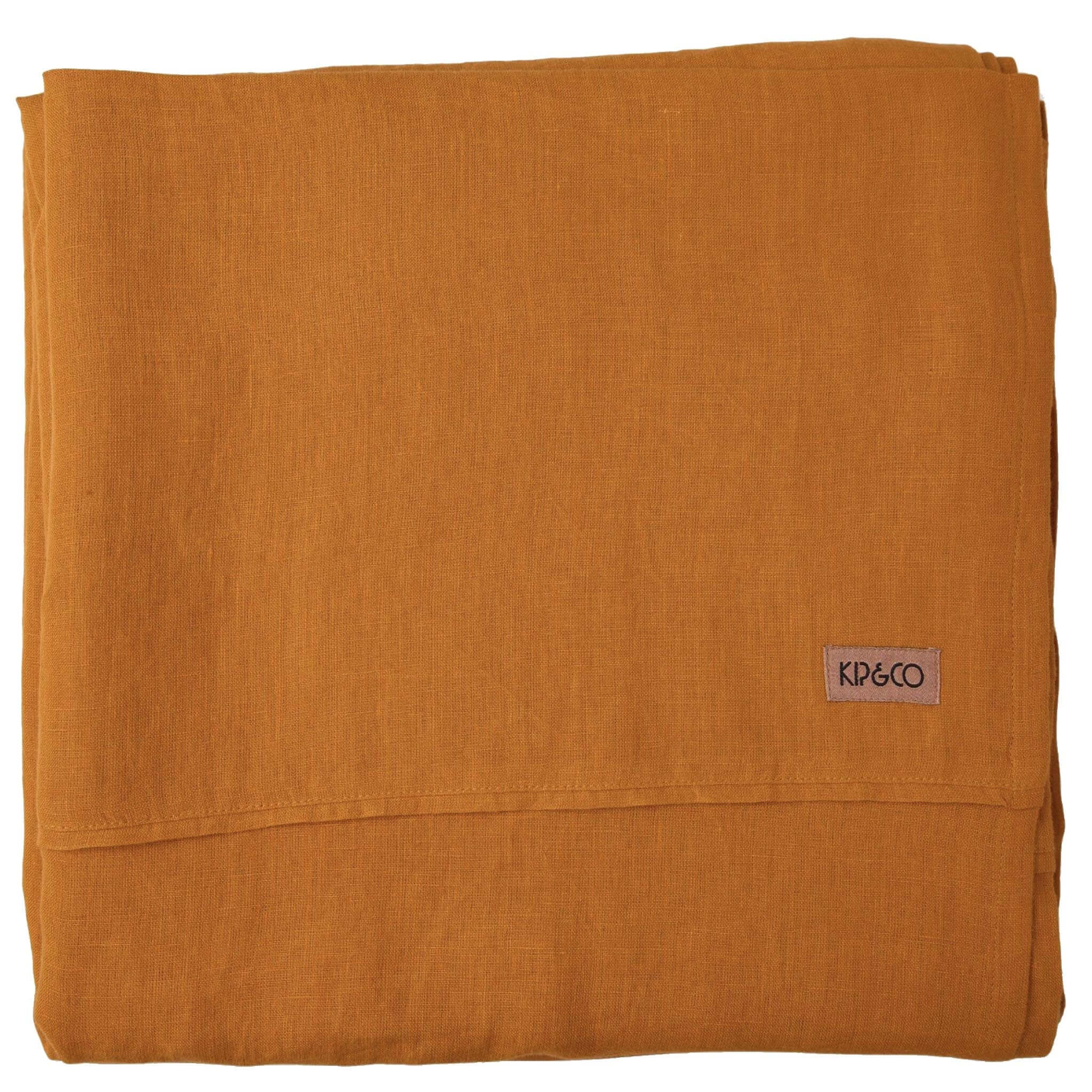 Folded orange flat sheet with a brand label on a white background