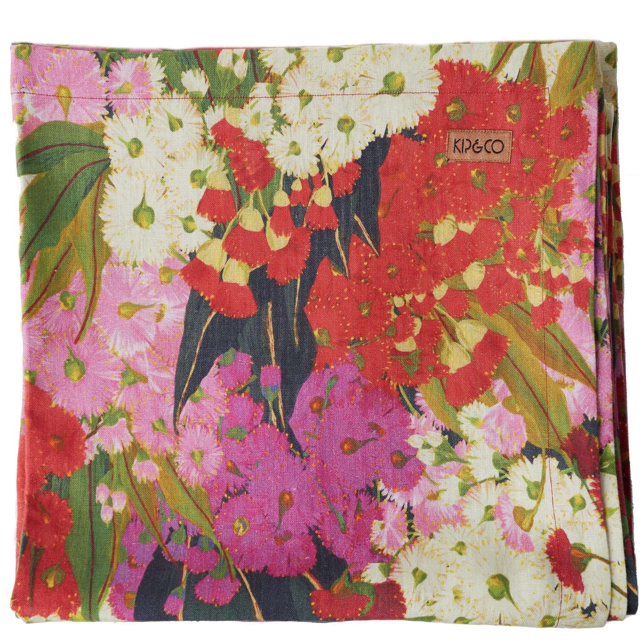 Floral patterned tablecloth with 'Kip & Co' branding on a white background