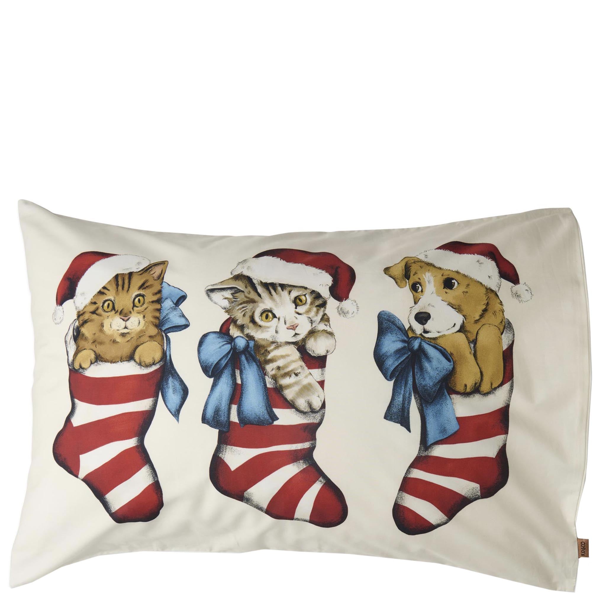 Decorative pillow with Christmas-themed illustrations of cats and a dog in stockings on a white background.