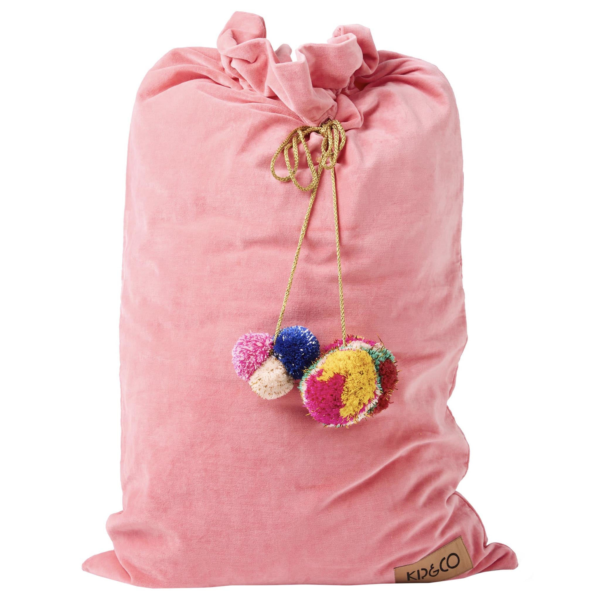 Pink drawstring bag with colorful pom-poms and a brand label on a white background