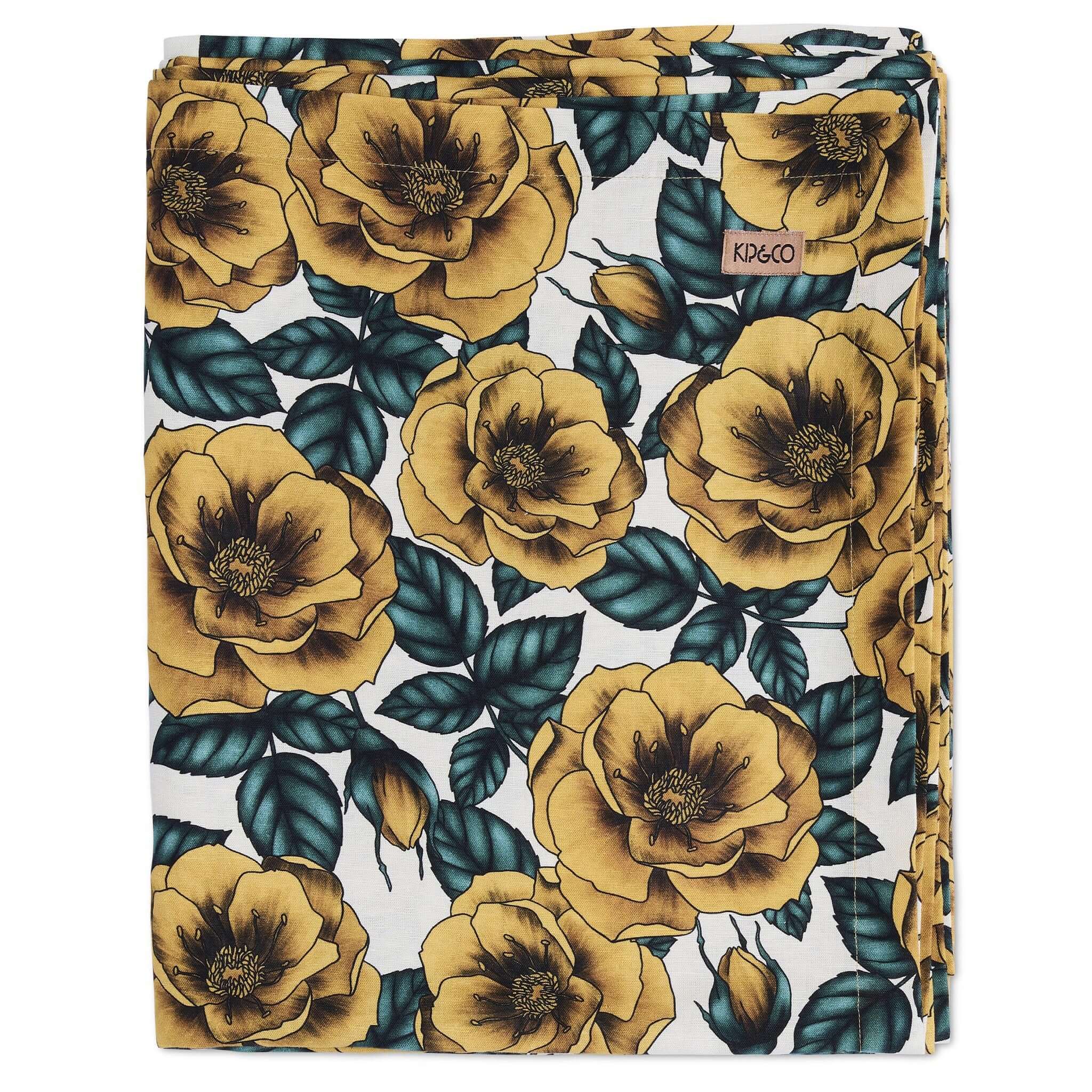 Alt Tag: Kip & Co Linen & Cotton Tablecloth - Golden Peony folded linen-cotton tablecloth with golden peonies and blue leaves