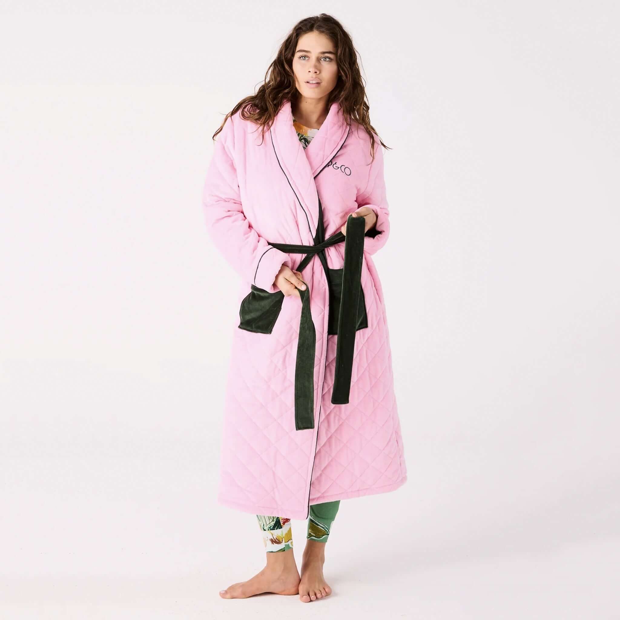 Alt Tag: Kip & Co Quilted Velvet Robe - Candy Pine quilted velvet robe with waist tie and patch pockets, worn full length for cosy warmth