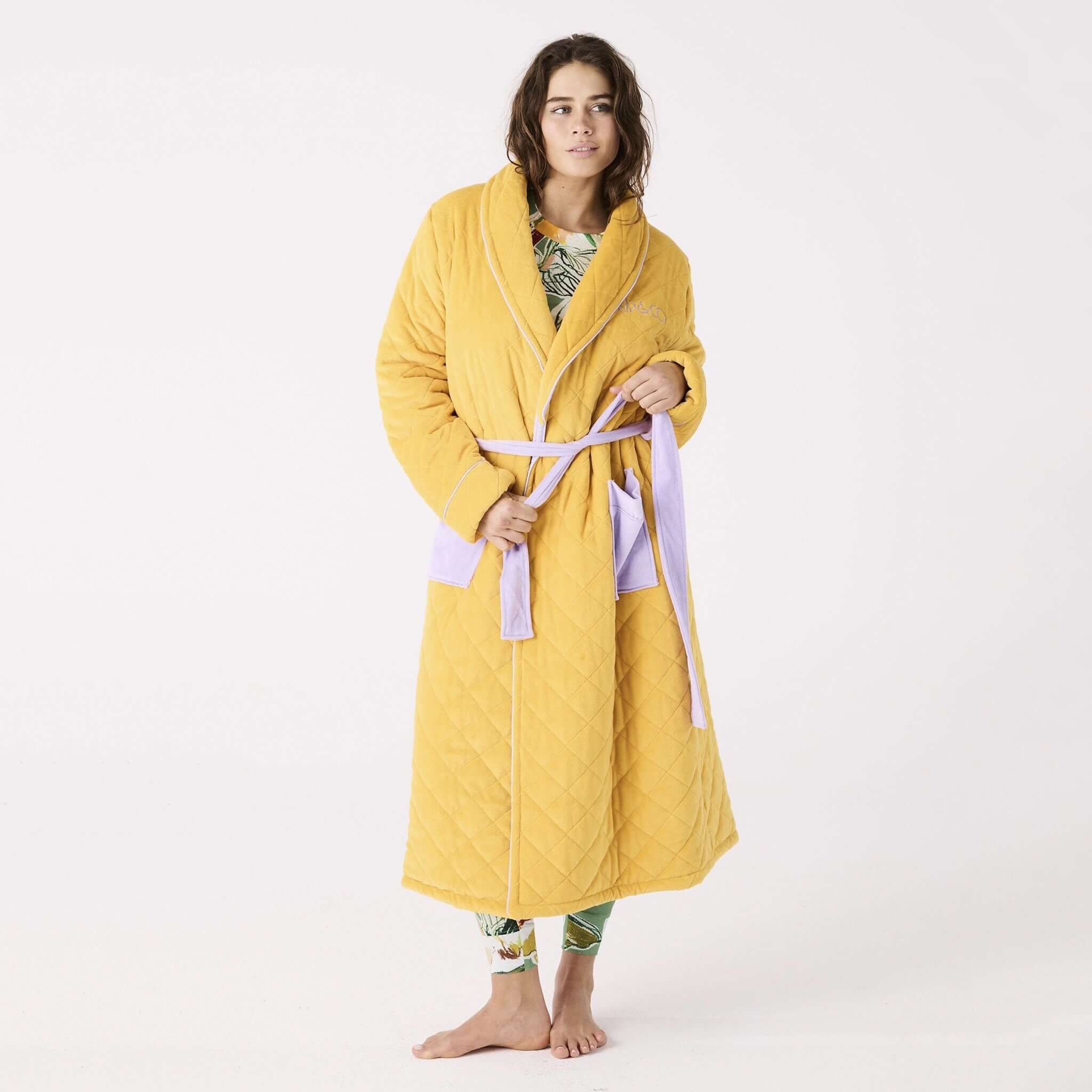 Alt Tag: Kip & Co Quilted Velvet Robe - Lavender Honey quilted honey robe with mauve patch pockets and waist tie, worn by model