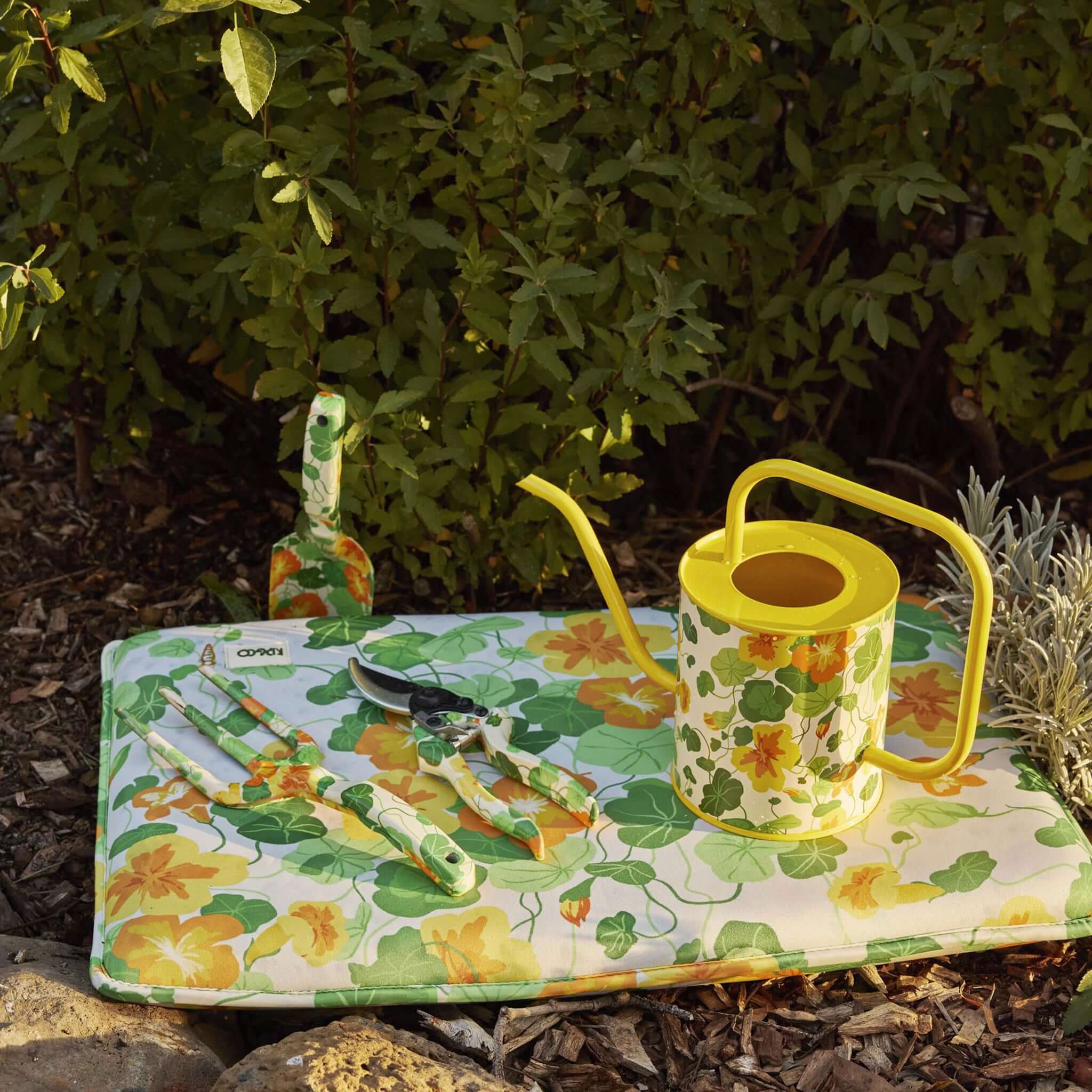 Alt Tag: Kip & Co Garden Tools & Gloves Set - Nasturtium floral hand tools and yellow watering can on garden mat outdoors