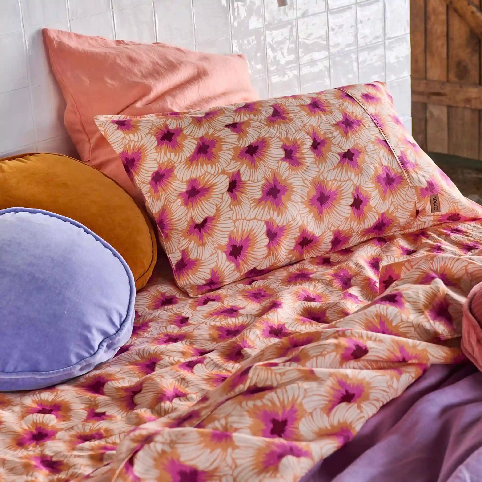 Floral patterned bedding with pillows on a bed