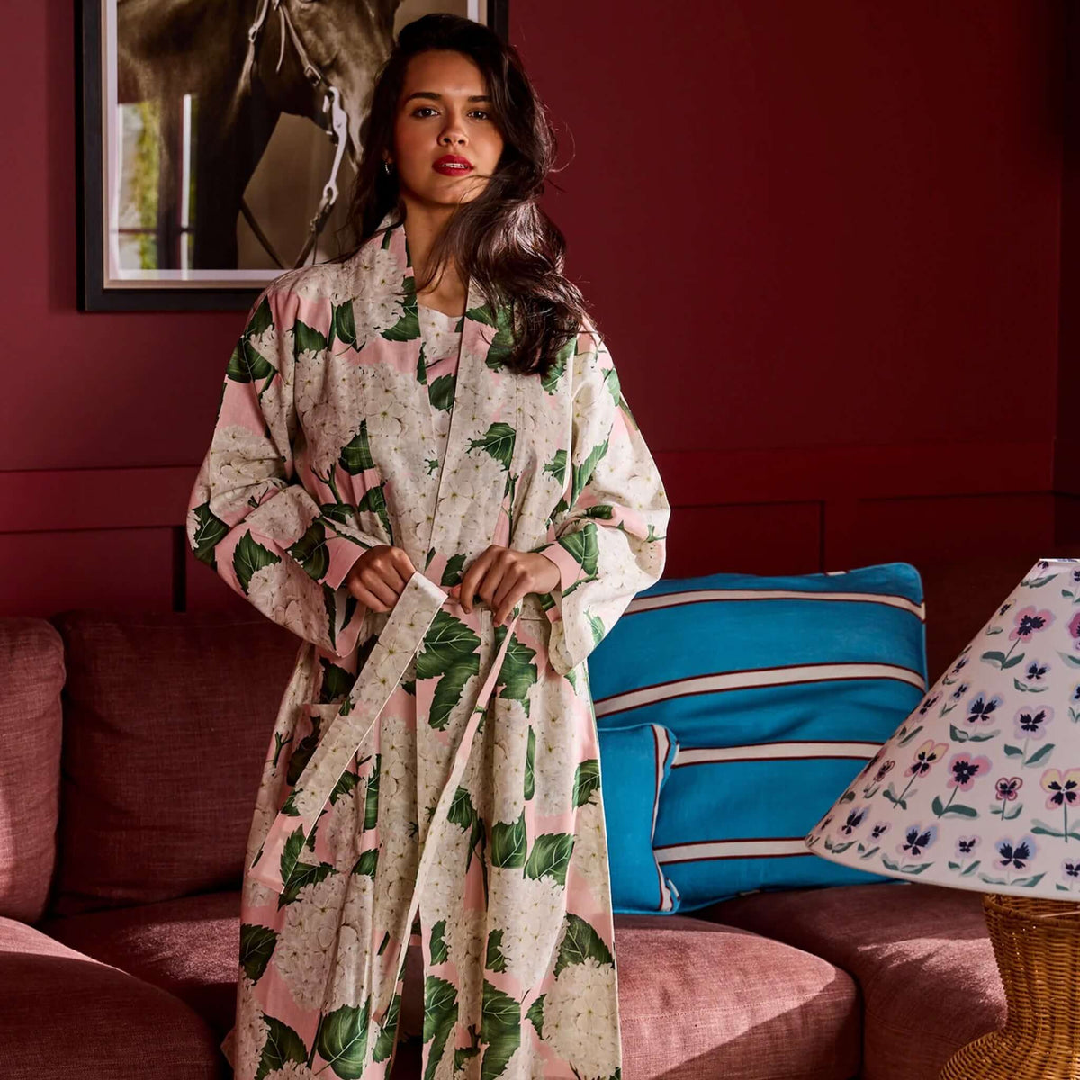 Kip & Co Linen Robe - Hydrangea Pink worn by a model in a cozy setting, perfect for relaxing at home.