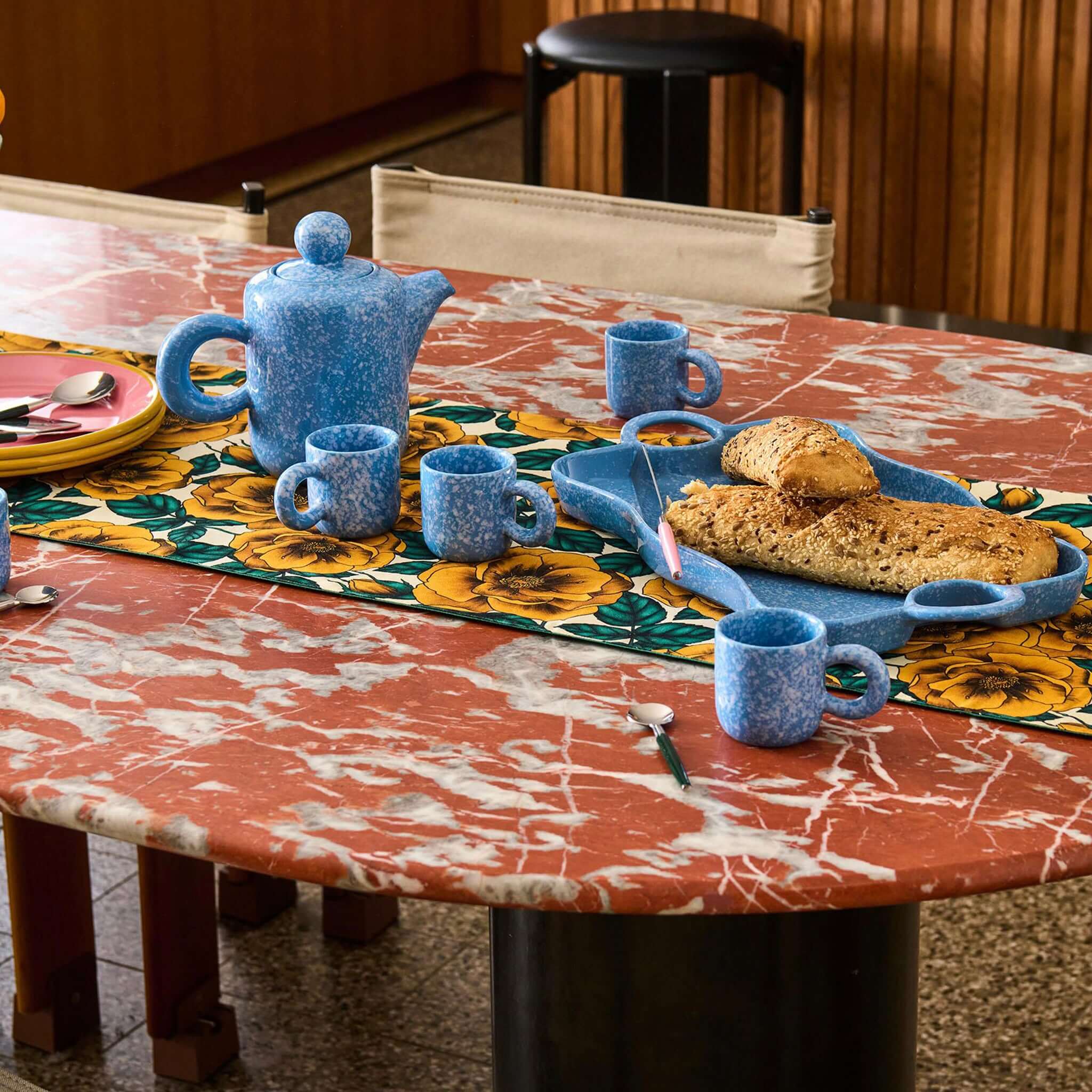 Alt Tag: Kip & Co Linen Table Runner - Golden Peony floral linen-cotton table runner styled with blue tea set and bread platter