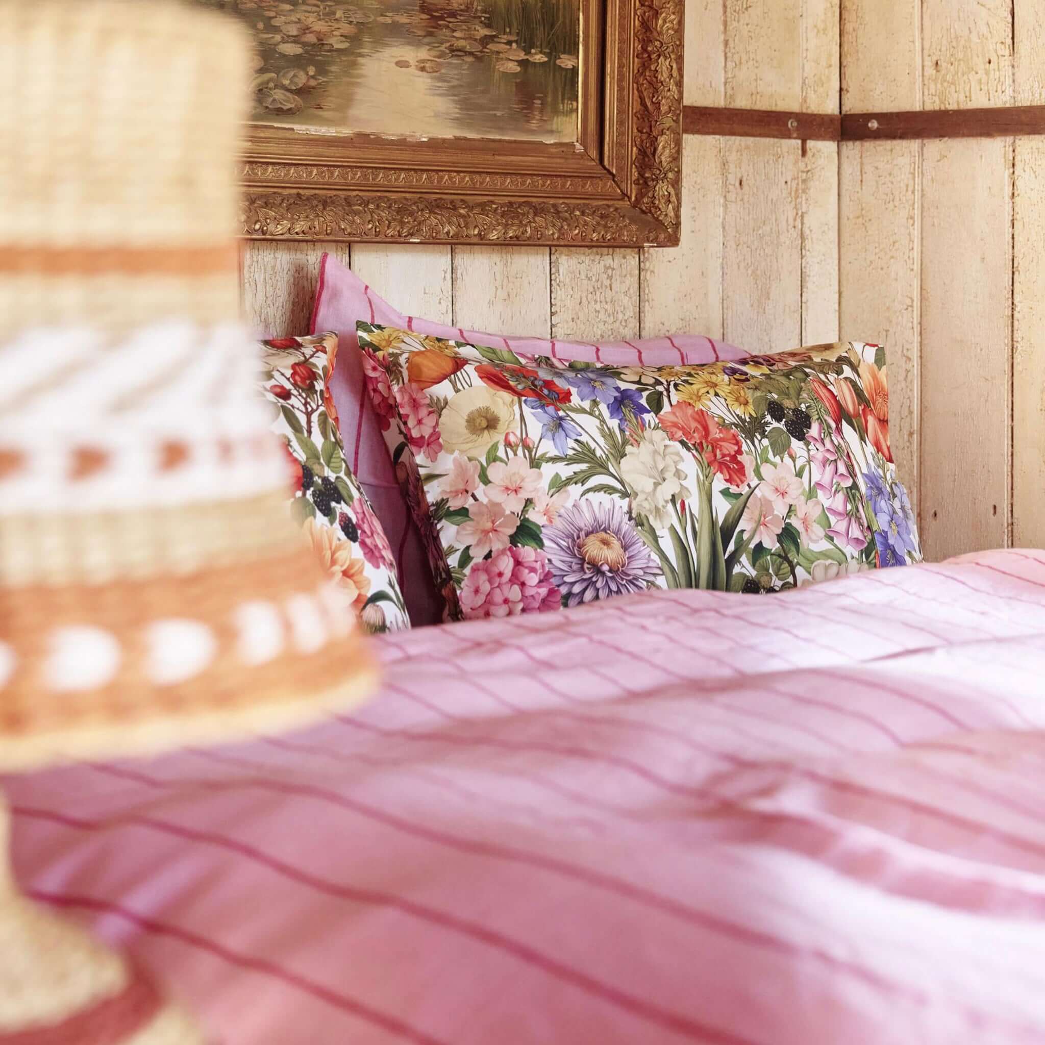 Alt Tag: Kip & Co Silk Pillowslip - Cottage Garden floral mulberry silk pillowcase on bed, cottage-style bedroom for smooth hair and skin