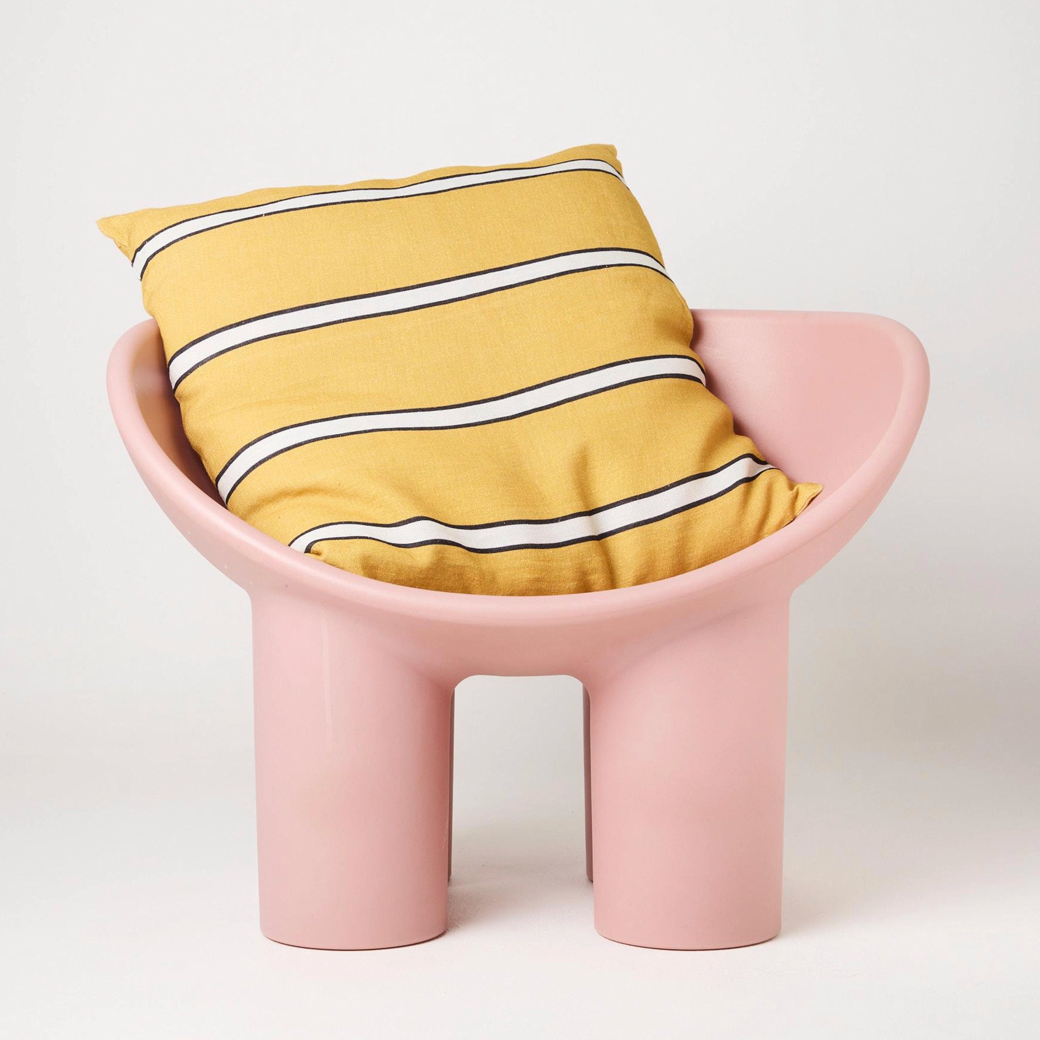 Pink chair with a yellow cushion featuring white stripes on a white background