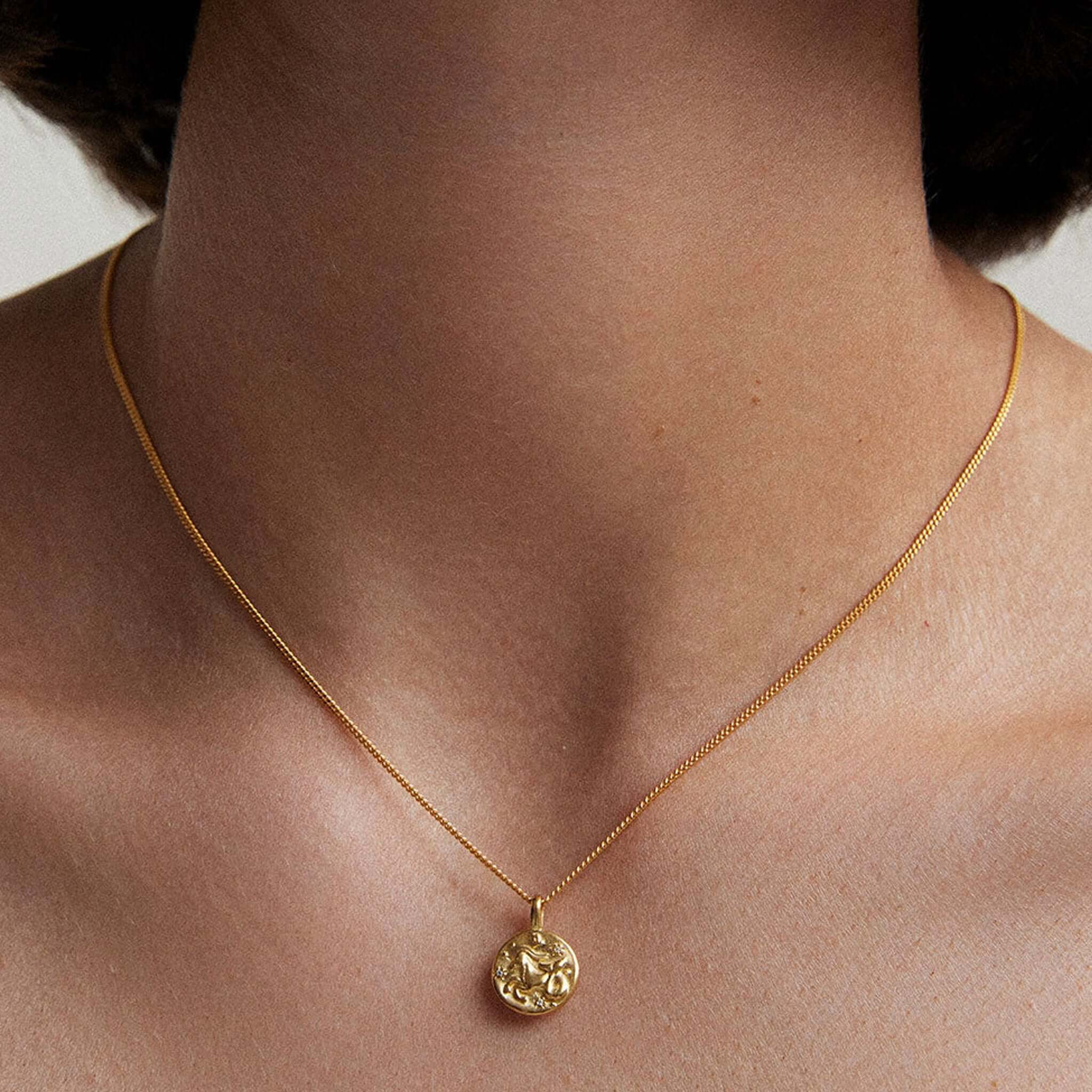 Alt Tag: Kirstin Ash Petite Zodiac Charm - Capricorn gold Capricorn zodiac charm necklace pendant on model