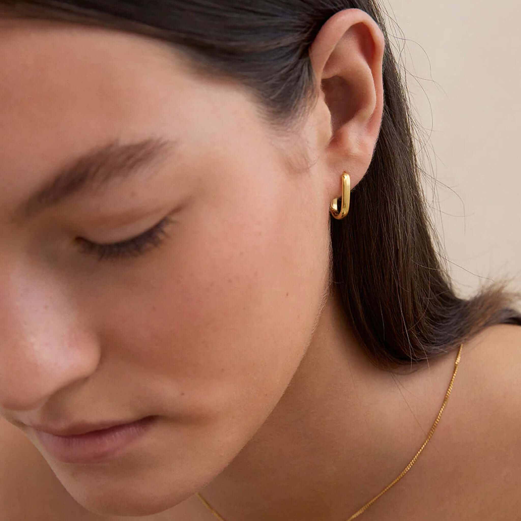 Kirstin Ash Roam Collection Roam Hoops - Small gold vermeil small hoop earrings worn on ear close-up