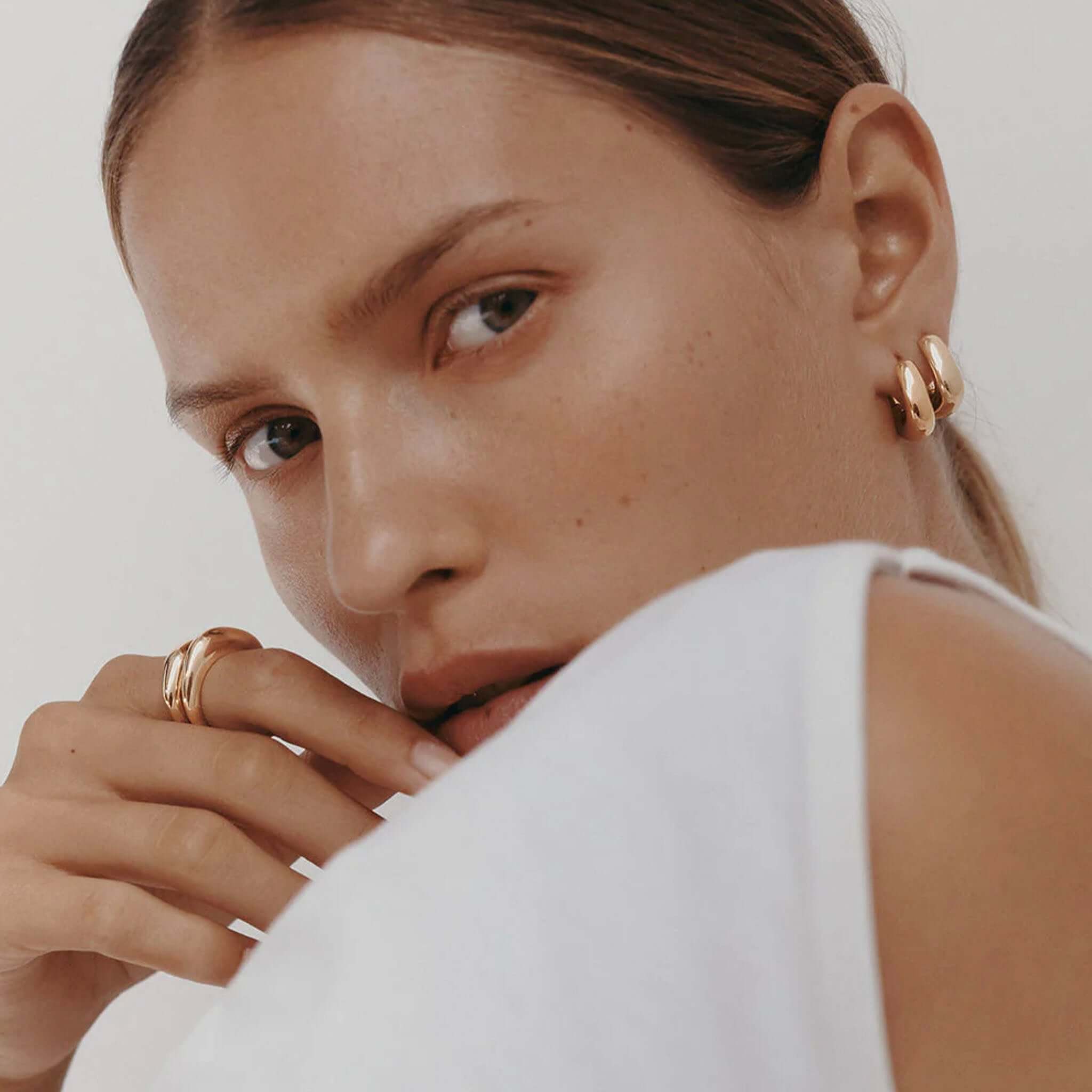 Alt Tag: Kirstin Ash Within Motion Collection Hoop Earrings in 18k gold vermeil on model, bold rounded hoop earrings with seamless curves