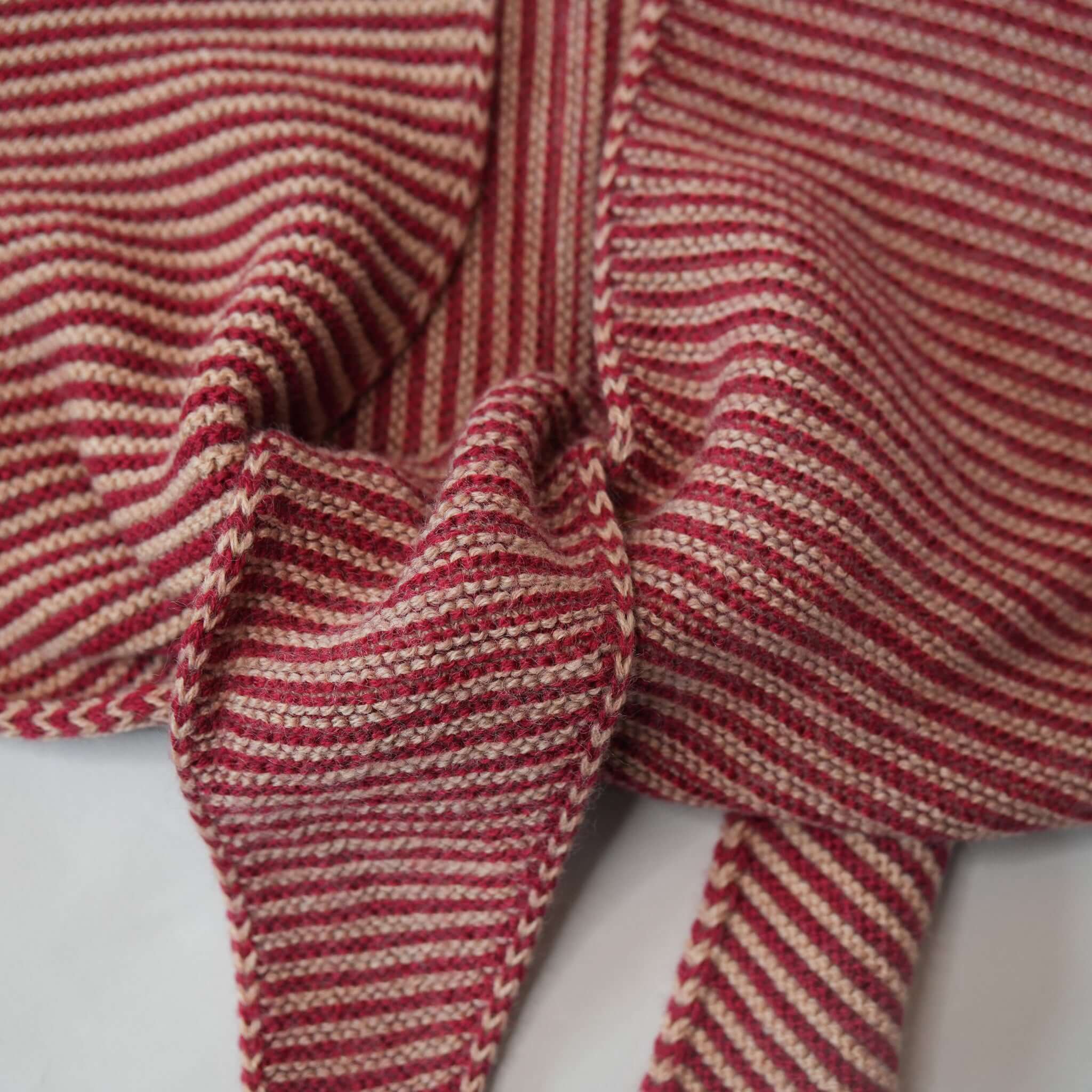 Knit Shepherd Punakaiki Merino Neckerchief - Rata Red detail showing the garter stitch pattern and texture.