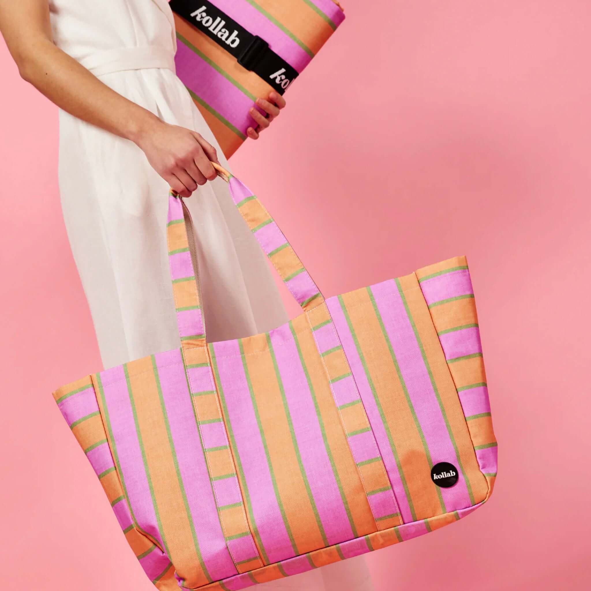 Person holding a striped tote bag with 'kollab' branding on a pink background