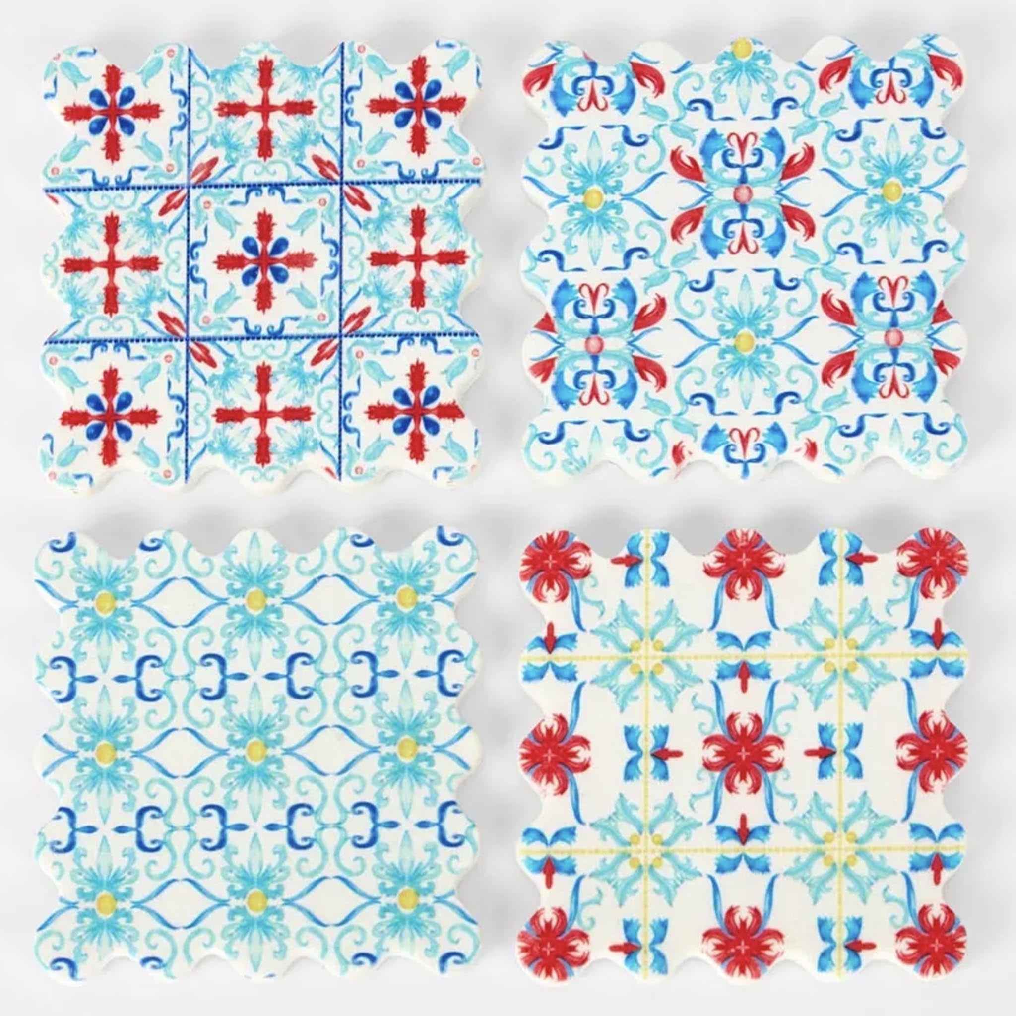 Set of four decorative coasters with floral patterns in red, blue, and white on a light gray background.