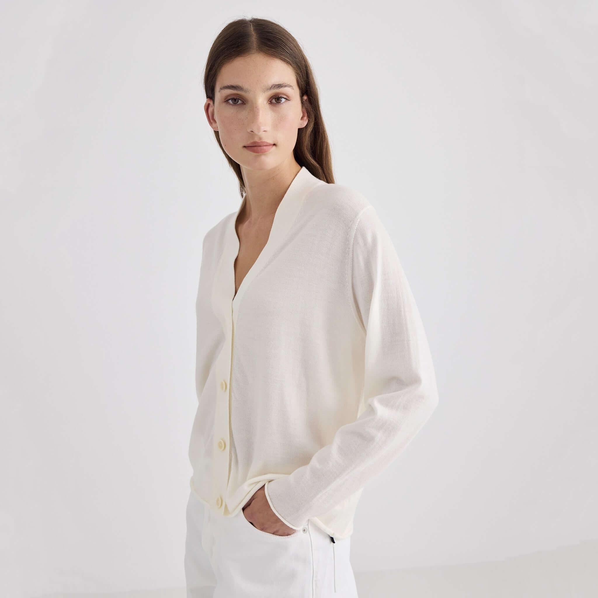 Laing Liv V-Neck Merino Cardigan - Cream model wearing in a minimalist setting.