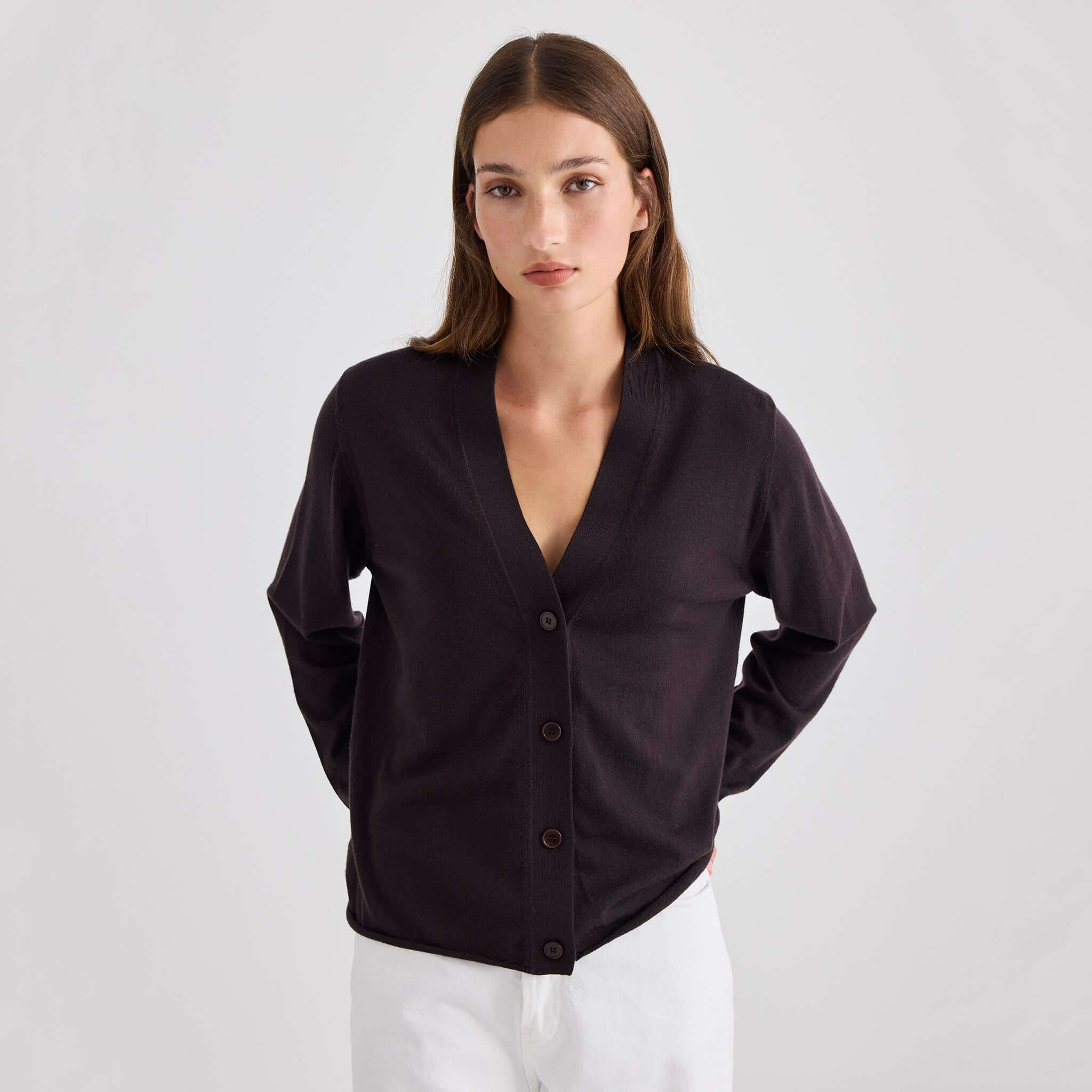 Laing Liv V-Neck Merino Cardigan - Chocolate worn by a model, showcasing its relaxed fit and fine New Zealand Merino material.