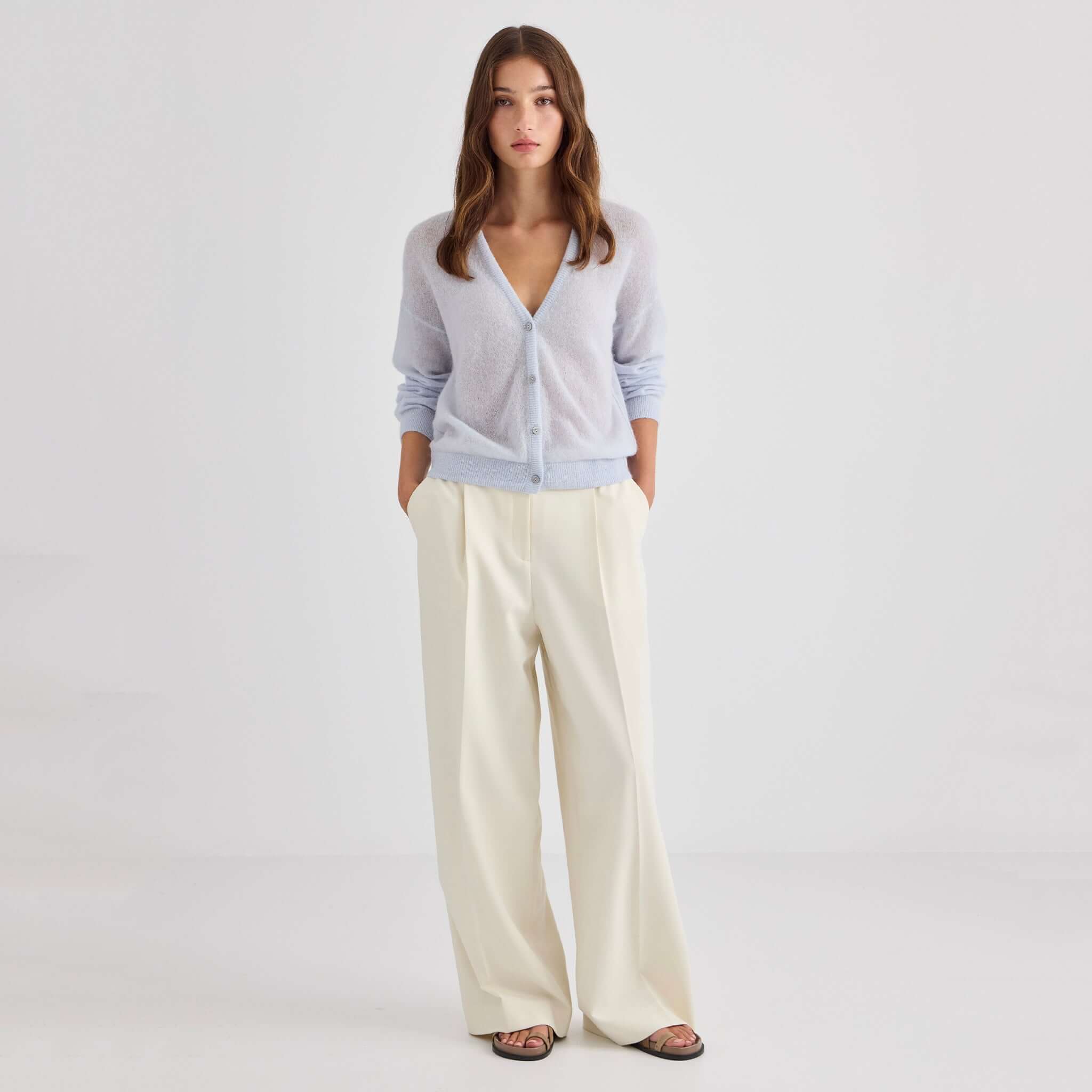 Laing Mila Alpaca & Merino Cardigan - Pale Blue worn with light trousers, showcasing a relaxed and stylish look.