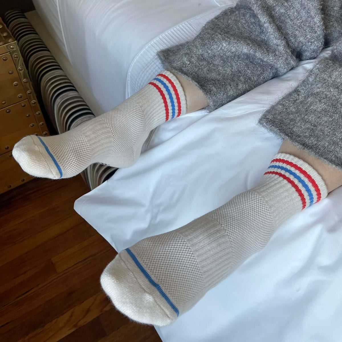 Le Bon Shoppe Girlfriend Socks - Leche cream crew socks with triple contrast stripes, worn with gray pants on bed