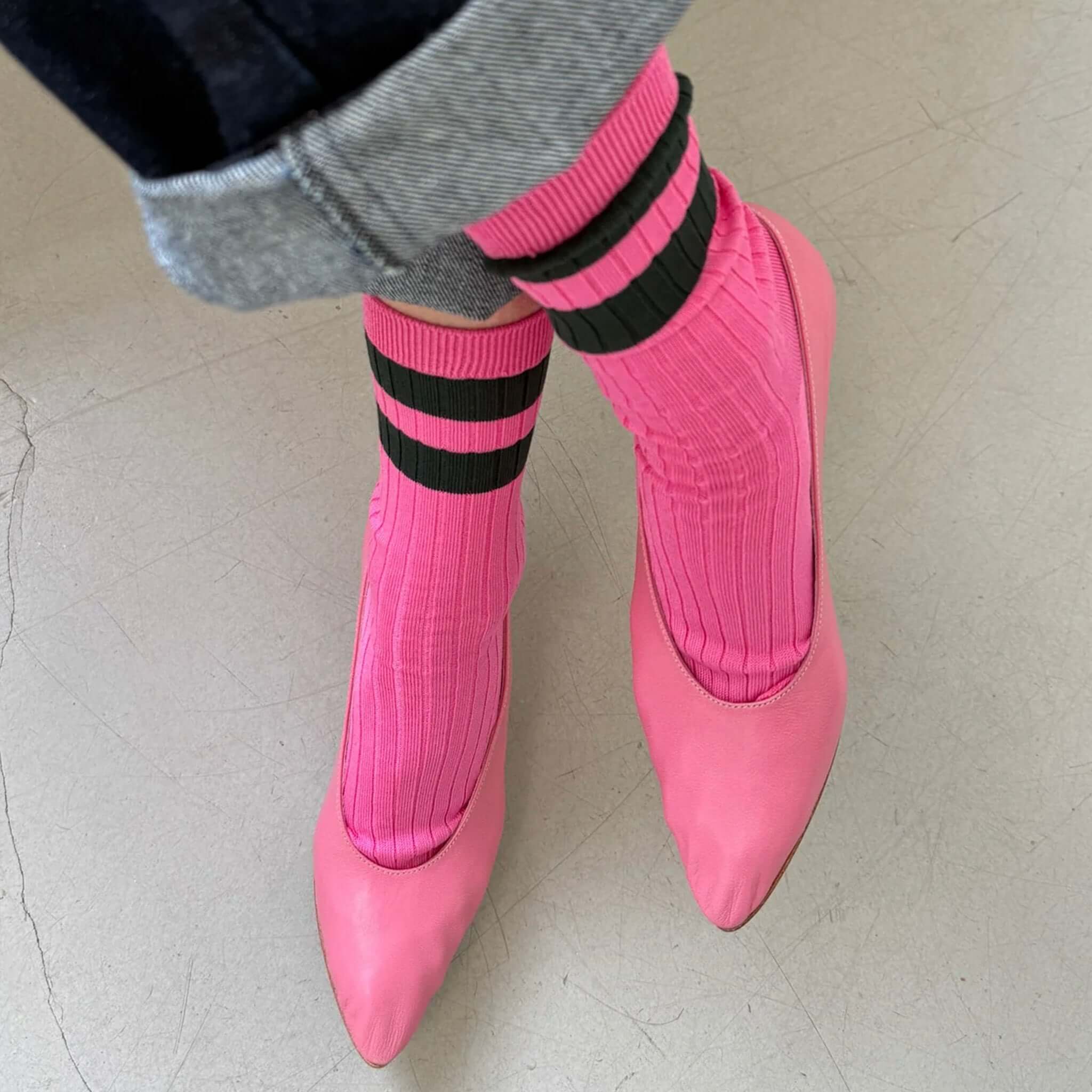 Alt Tag: Le Bon Shoppe Her Varsity Socks - Pink Green on feet, ribbed mercerized cotton socks with bold stripes, styled with pink heels
