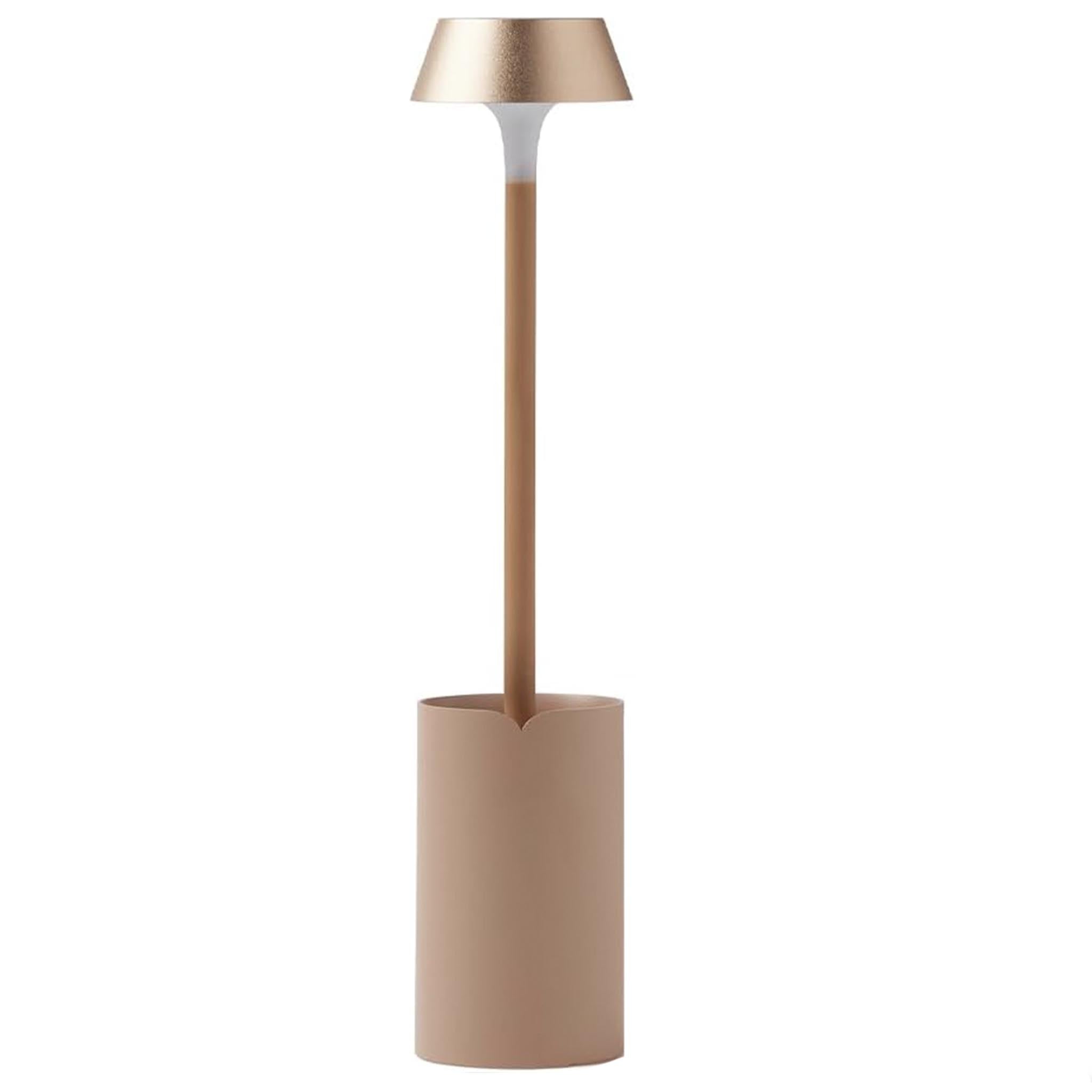 Modern clip on lamp with a cylindrical base and metallic shade on a white background