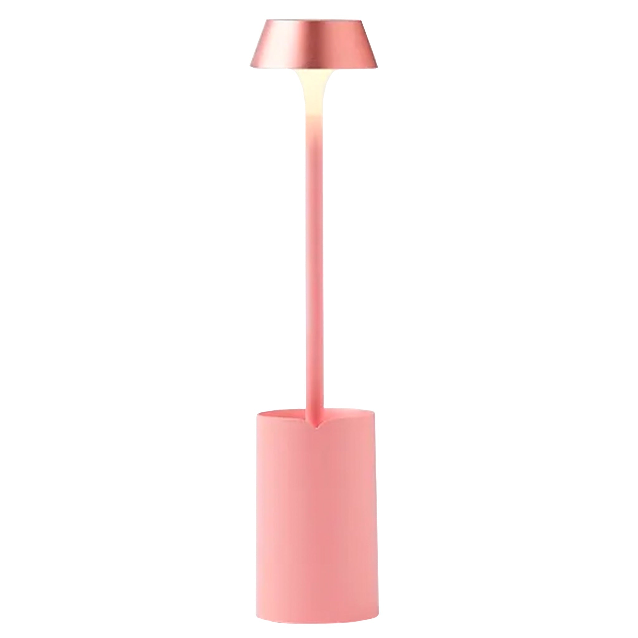 Lexon Mimi Clip-on Reading Lamp - Light Pink showcasing sleek design and warm LED lighting in a stylish home setting.
