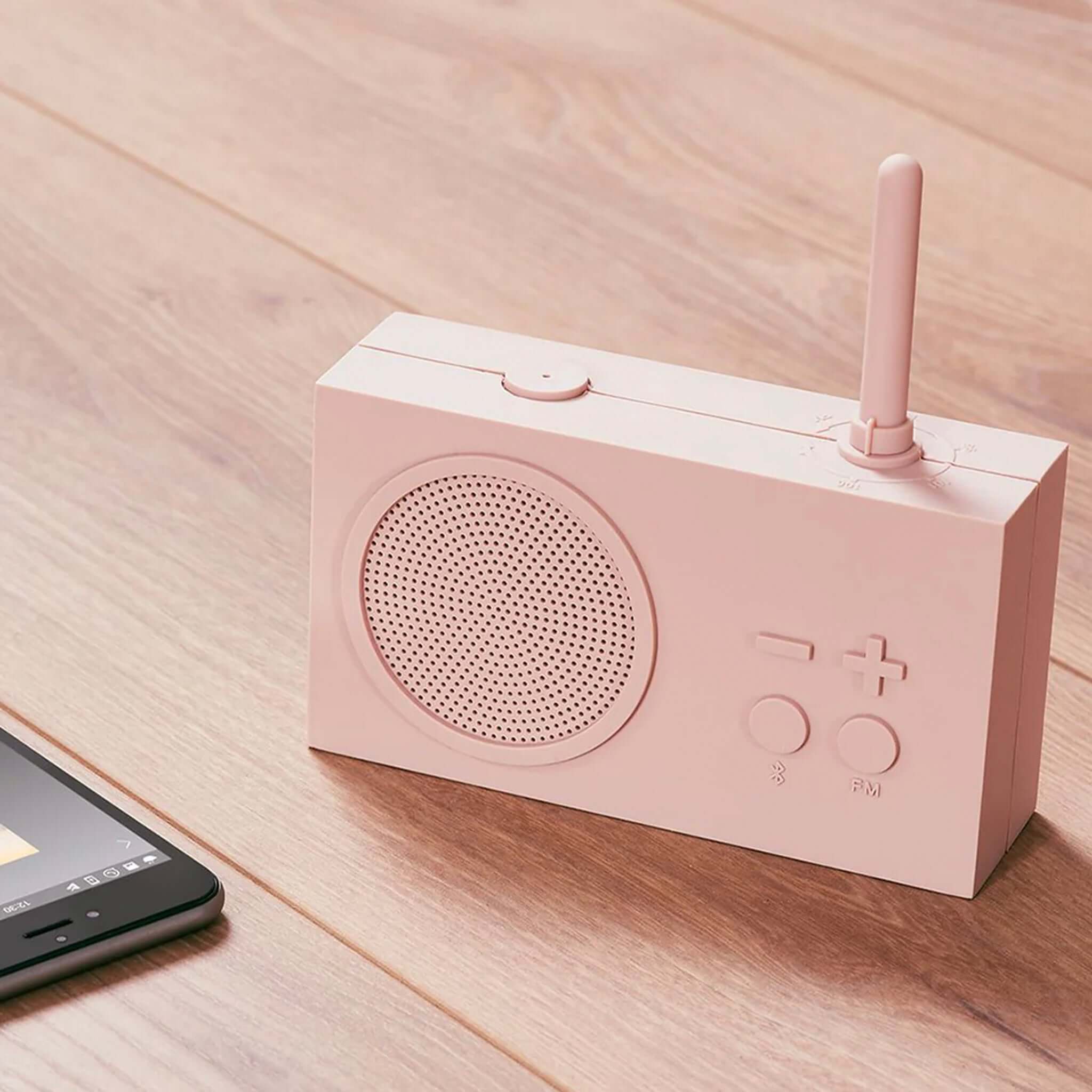 A pink Lexon TYKHO 3 FM radio and Bluetooth speaker with a antenna, speaker grilles, and control buttons on the front.