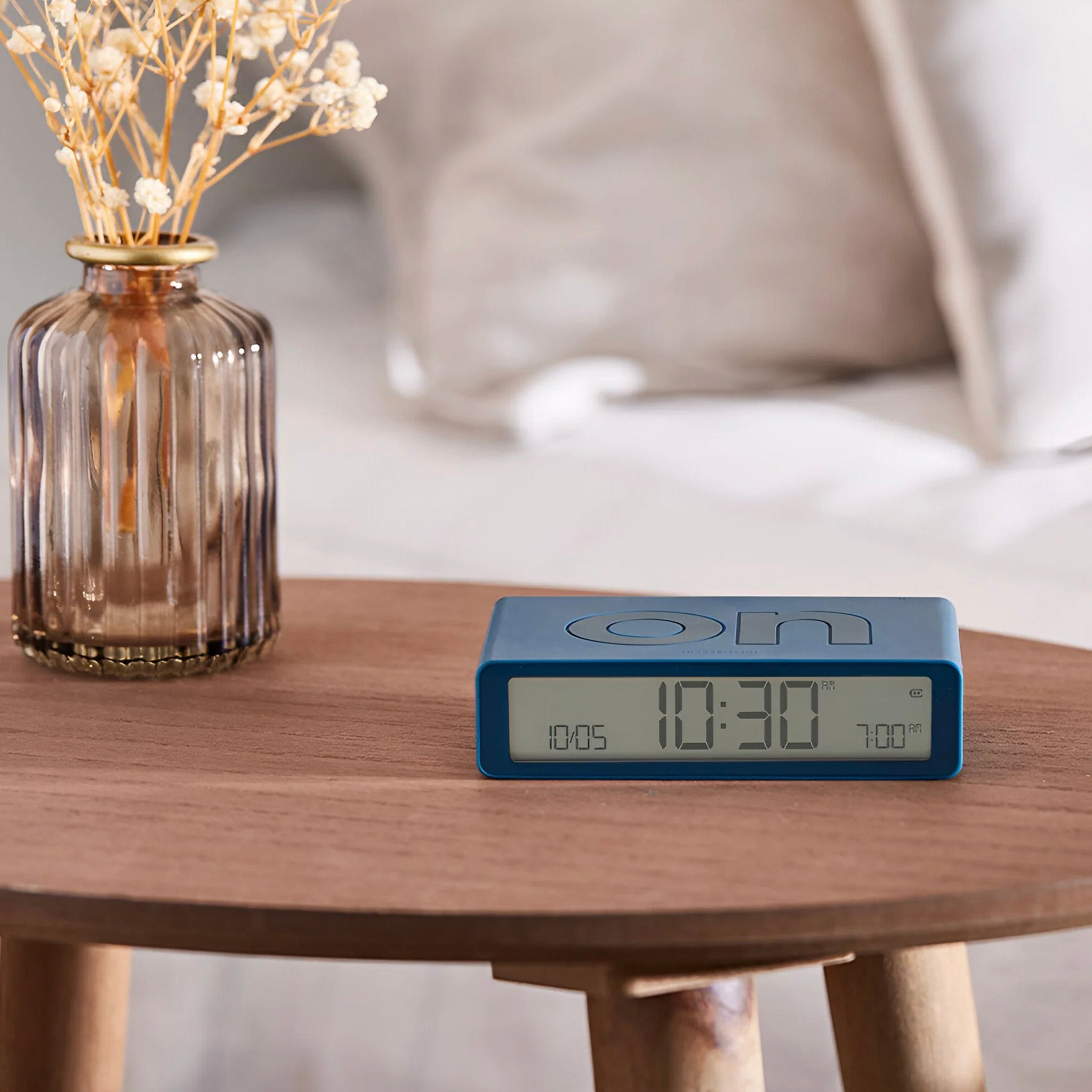 Duck blue alarm clock on a table.